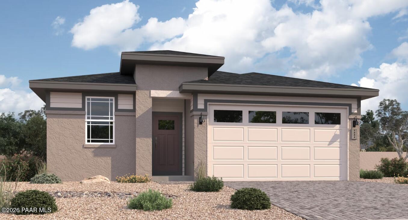 Modern beige stucco single-story home with 2-car garage, desert landscaping, and paver driveway in Prescott, AZ - Davidson Homes Coronado A