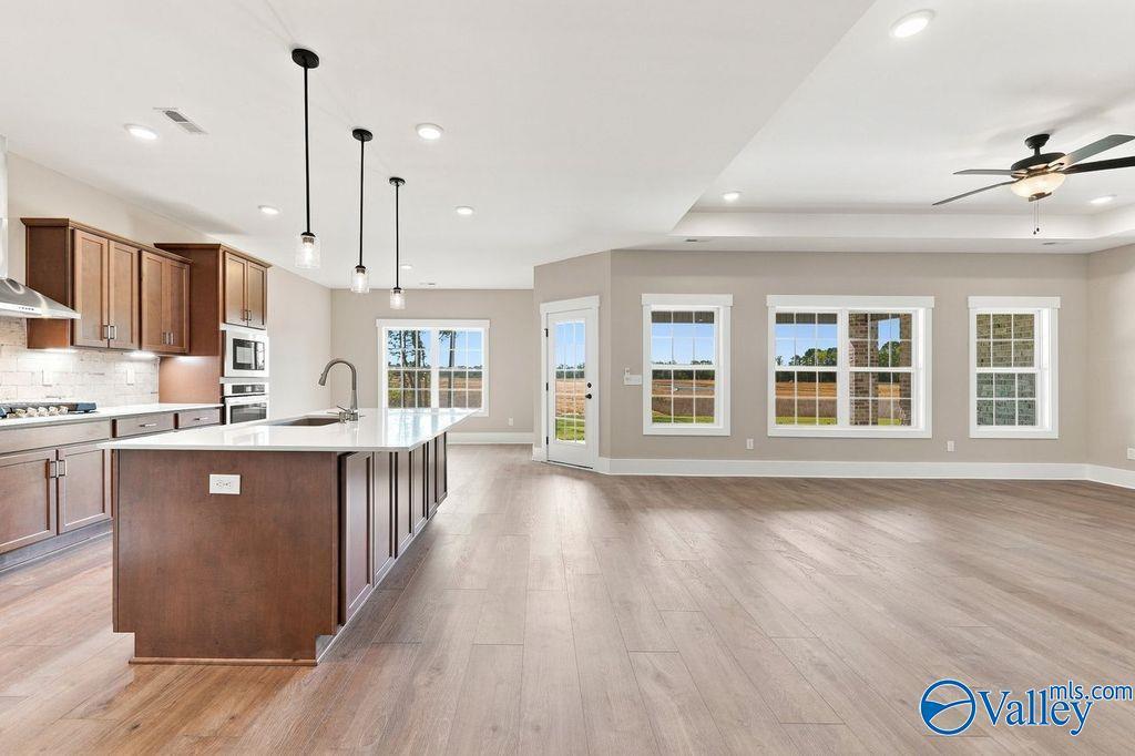Open-concept kitchen and living area in The Rockford floor plan by Davidson Homes in Cain Park, Hartselle, Alabama.