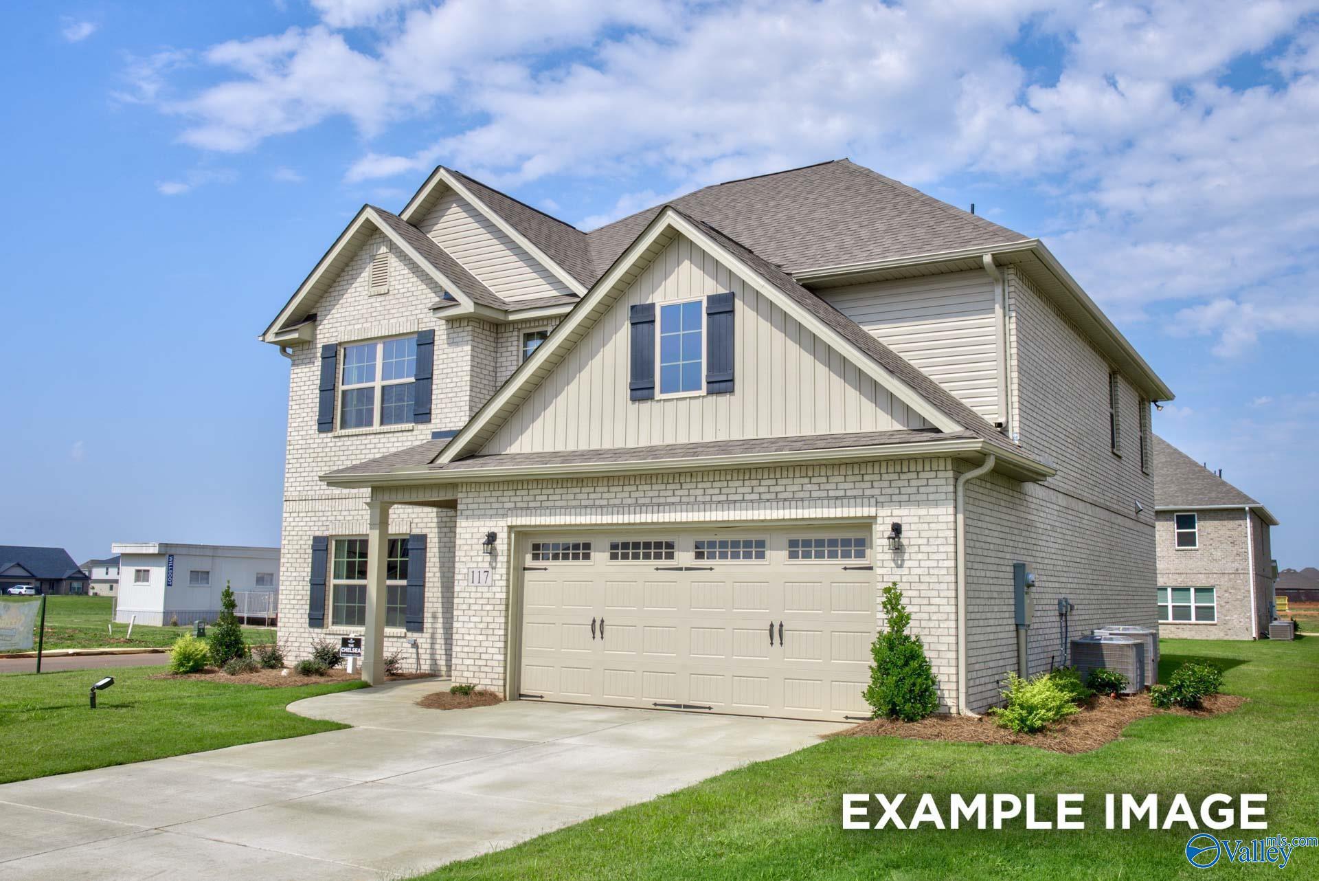 Two-story brick exterior with 2-car garage and landscaped yard, The Chelsea A by Davidson Homes in Ivy Hills, Toney, Alabama