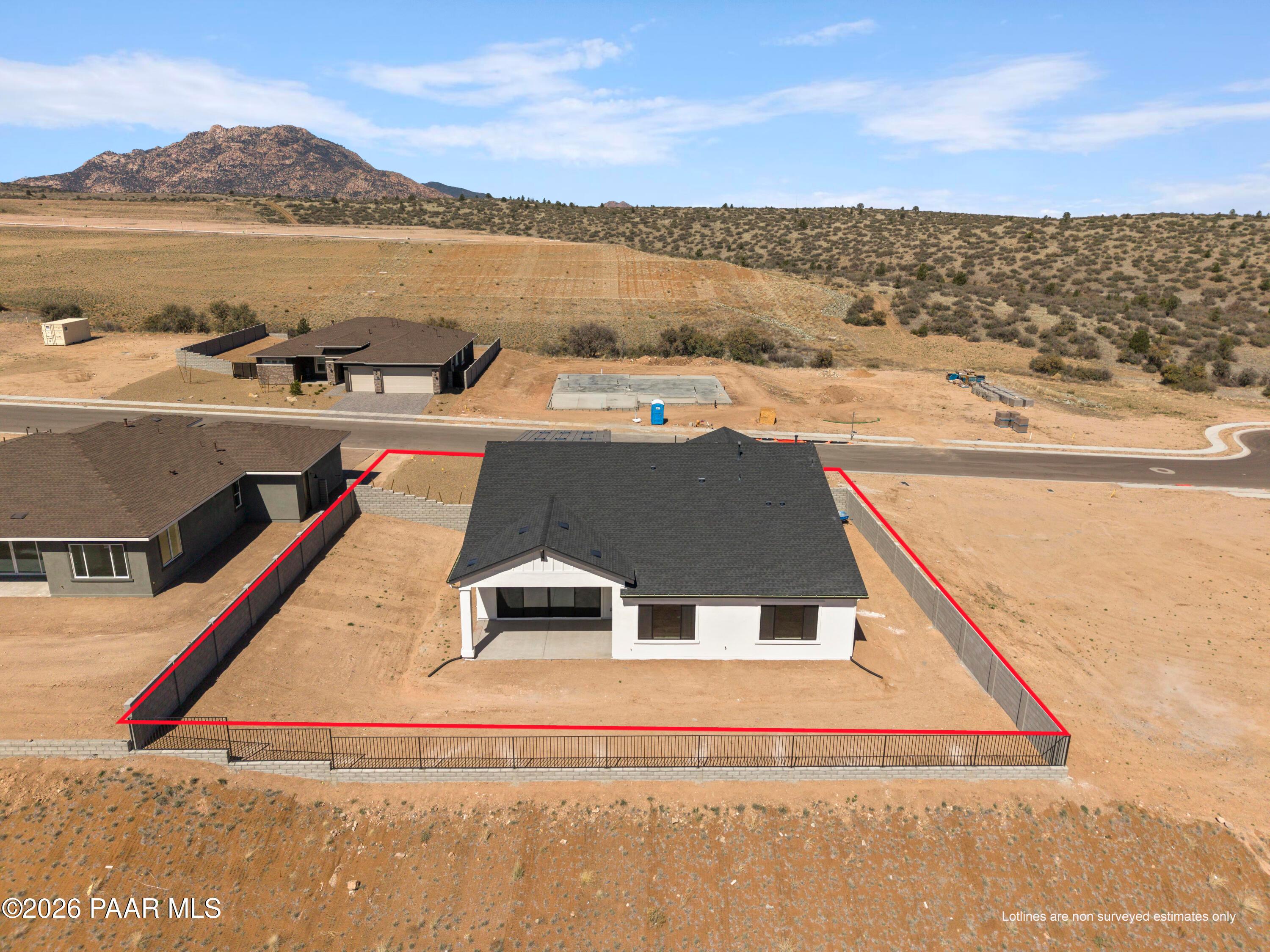 Aerial view of The Soleil E single-story home by Davidson Homes in Hidden Hills, Prescott, Arizona, fenced lot amid desert mountains