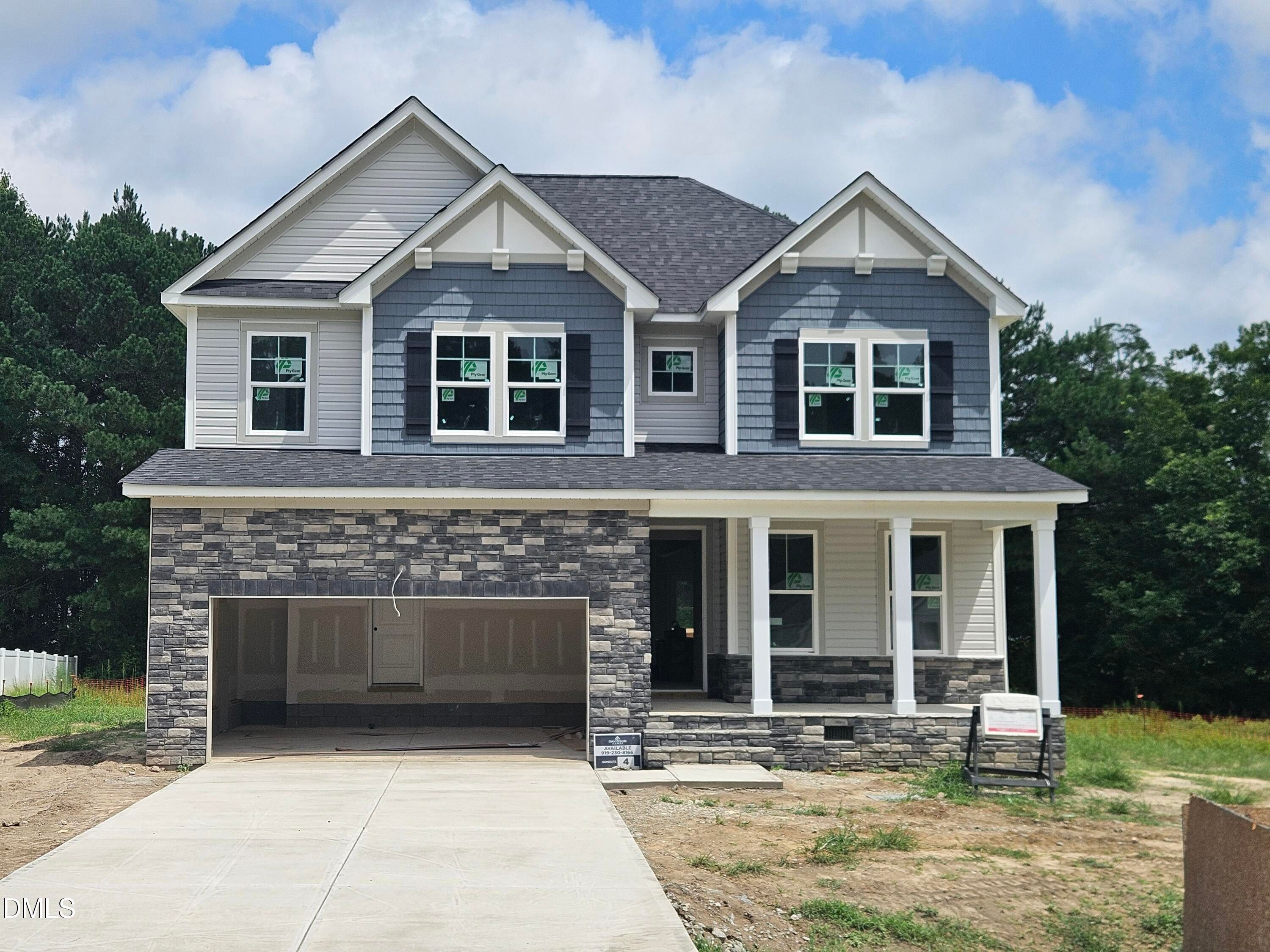 Two-story Davidson Homes Willow D floor plan with stone facade and 2-car garage in Wellers Knoll, Lillington, North Carolina.