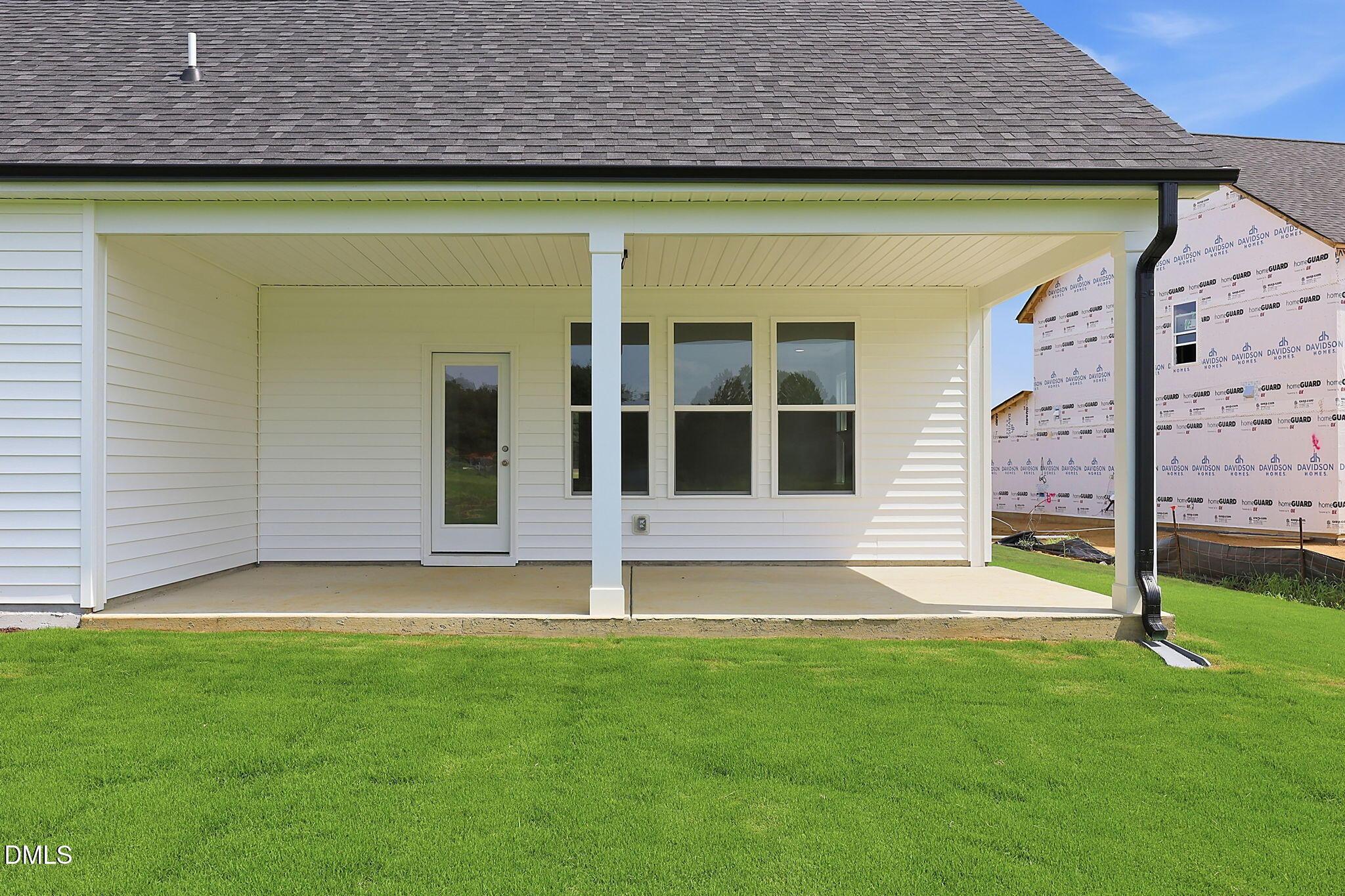 Covered back patio of The Magnolia B floor plan by Davidson Homes in Retreat at North Main, Lillington, North Carolina.