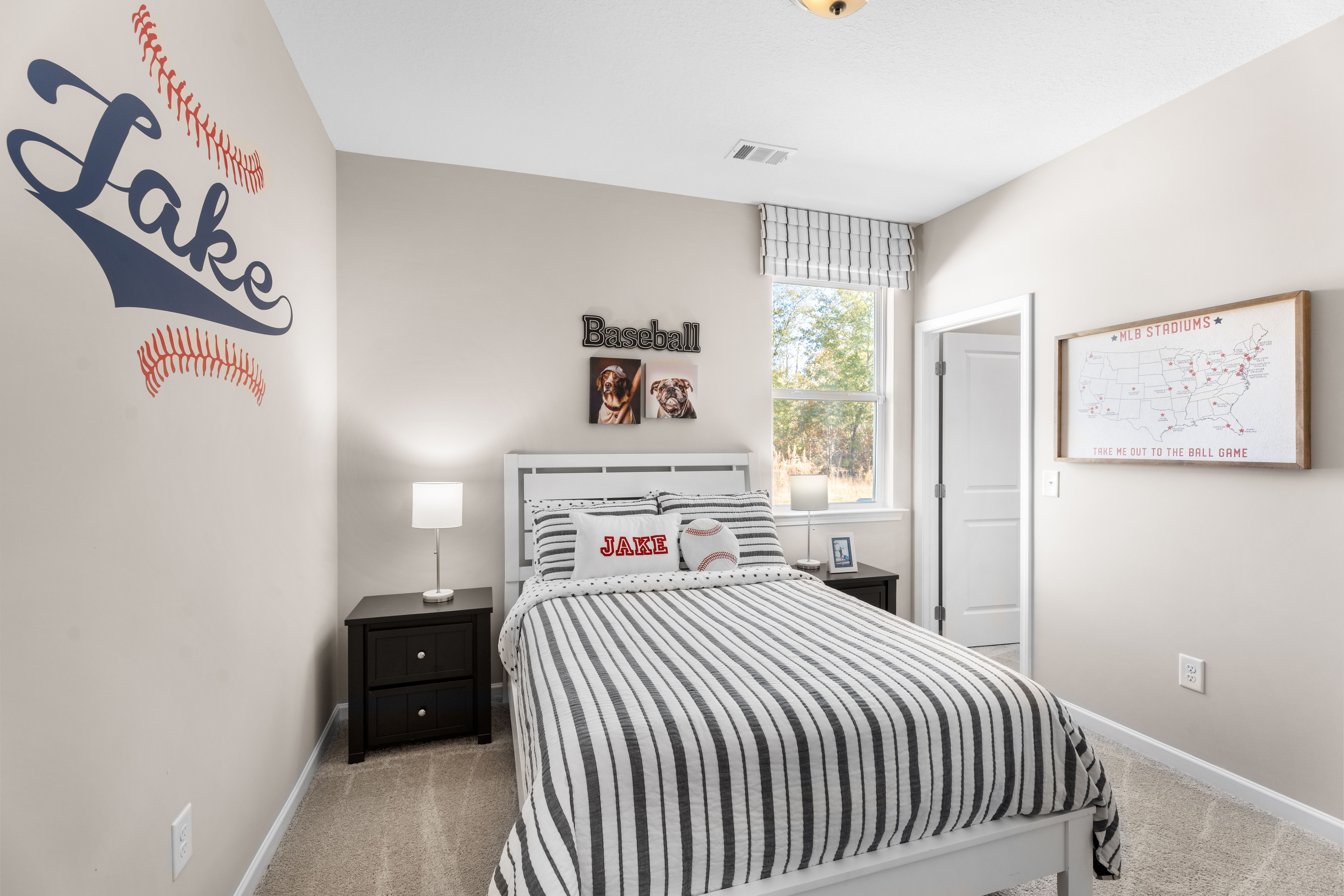 Baseball-themed boy's bedroom at Silver Oak in Cusseta Alabama with Jake wall decal, striped bedding, and baseball decor