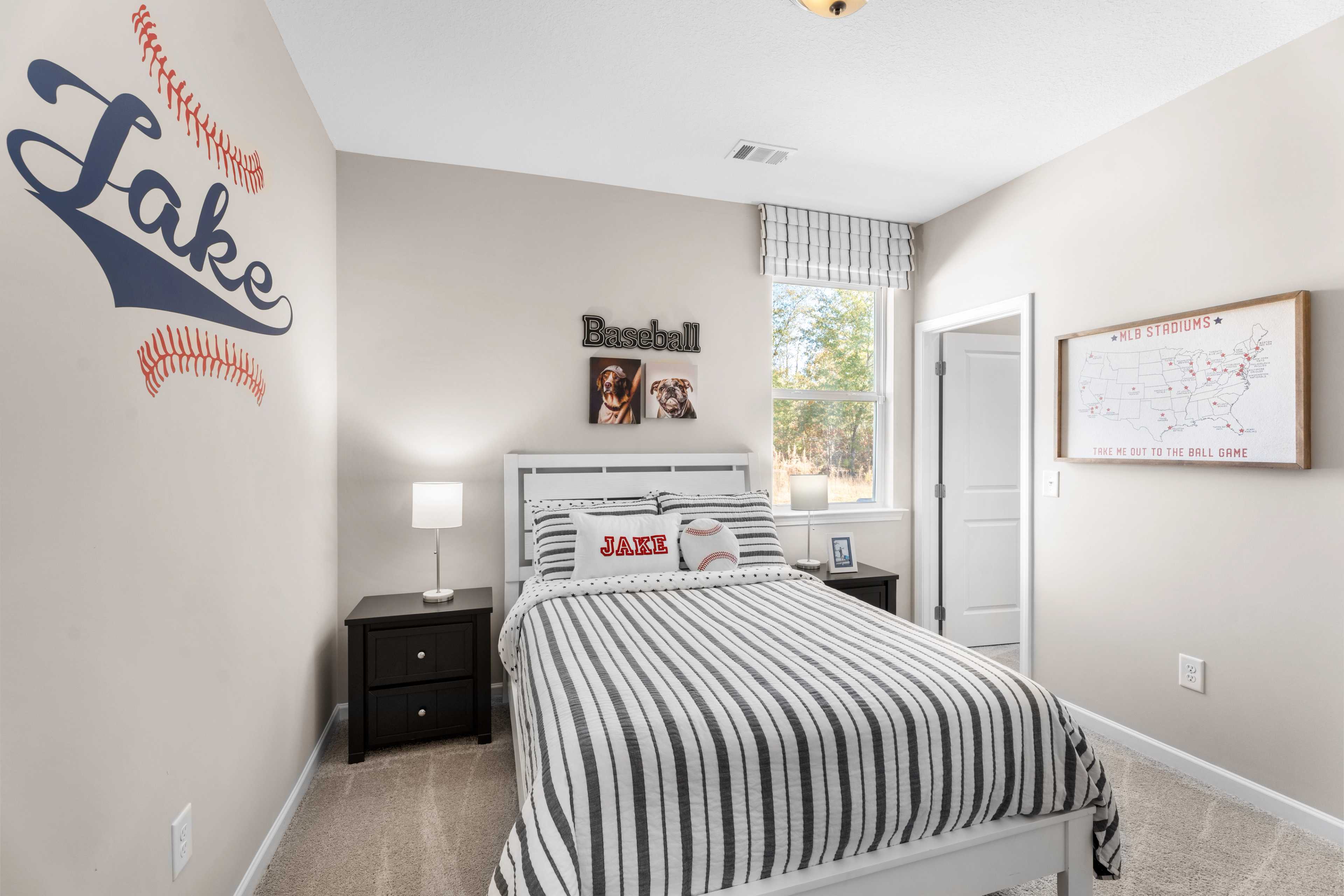 Baseball-themed boy's bedroom at Silver Oak in Cusseta Alabama with Jake wall decal, striped bedding, and baseball decor