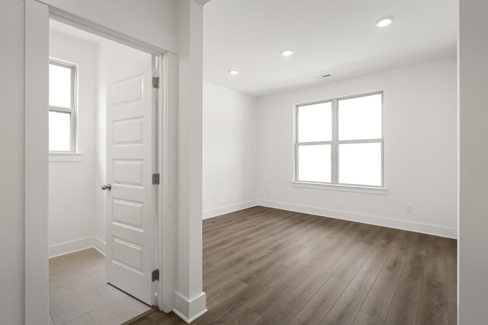 Bright, spacious bedroom with luxury vinyl plank flooring in The Ridgeport C floor plan at Woods Crossing, Gallatin, TN.