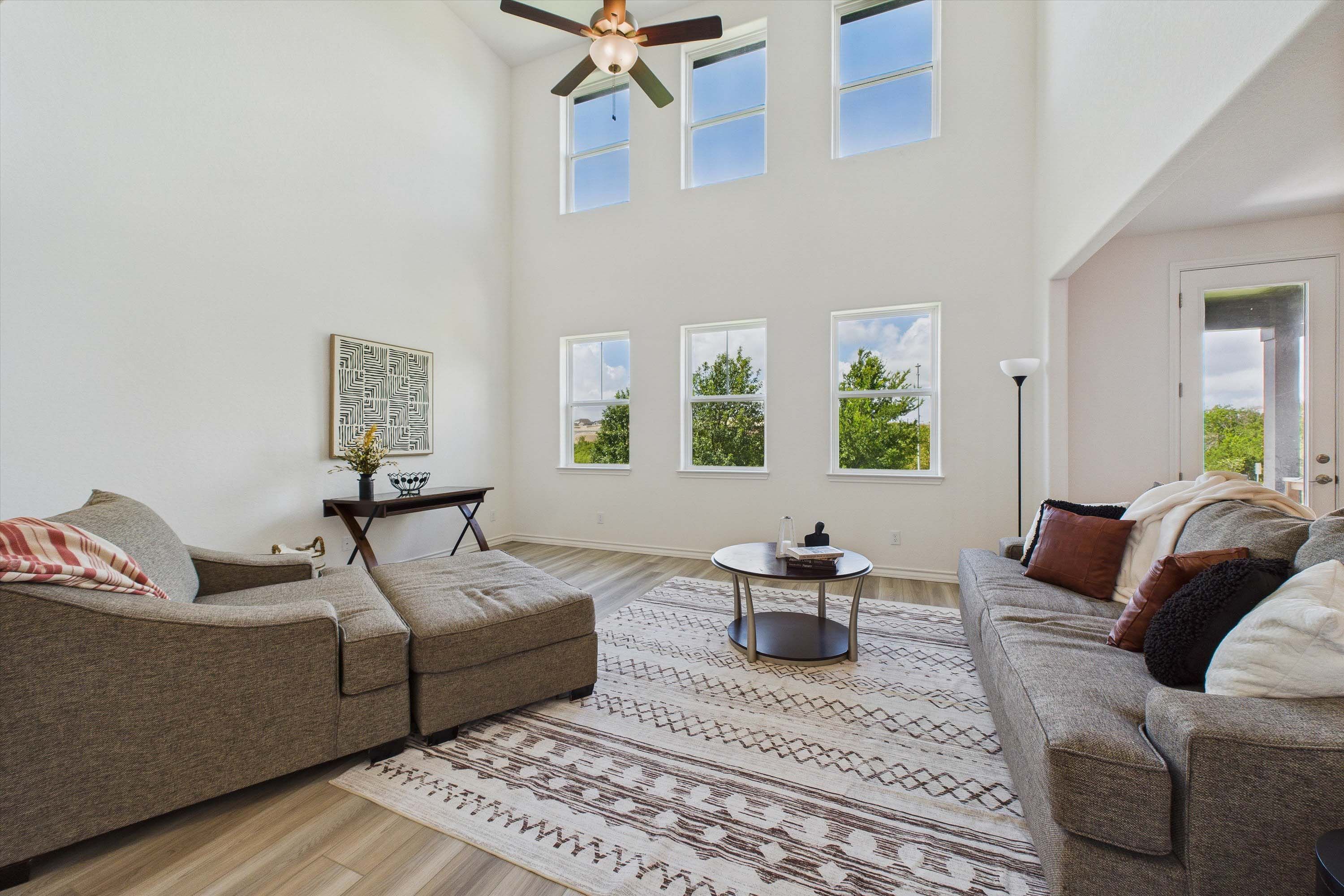 Spacious two-story living room in The Danbury by Davidson Homes featuring high ceilings and abundant natural light.