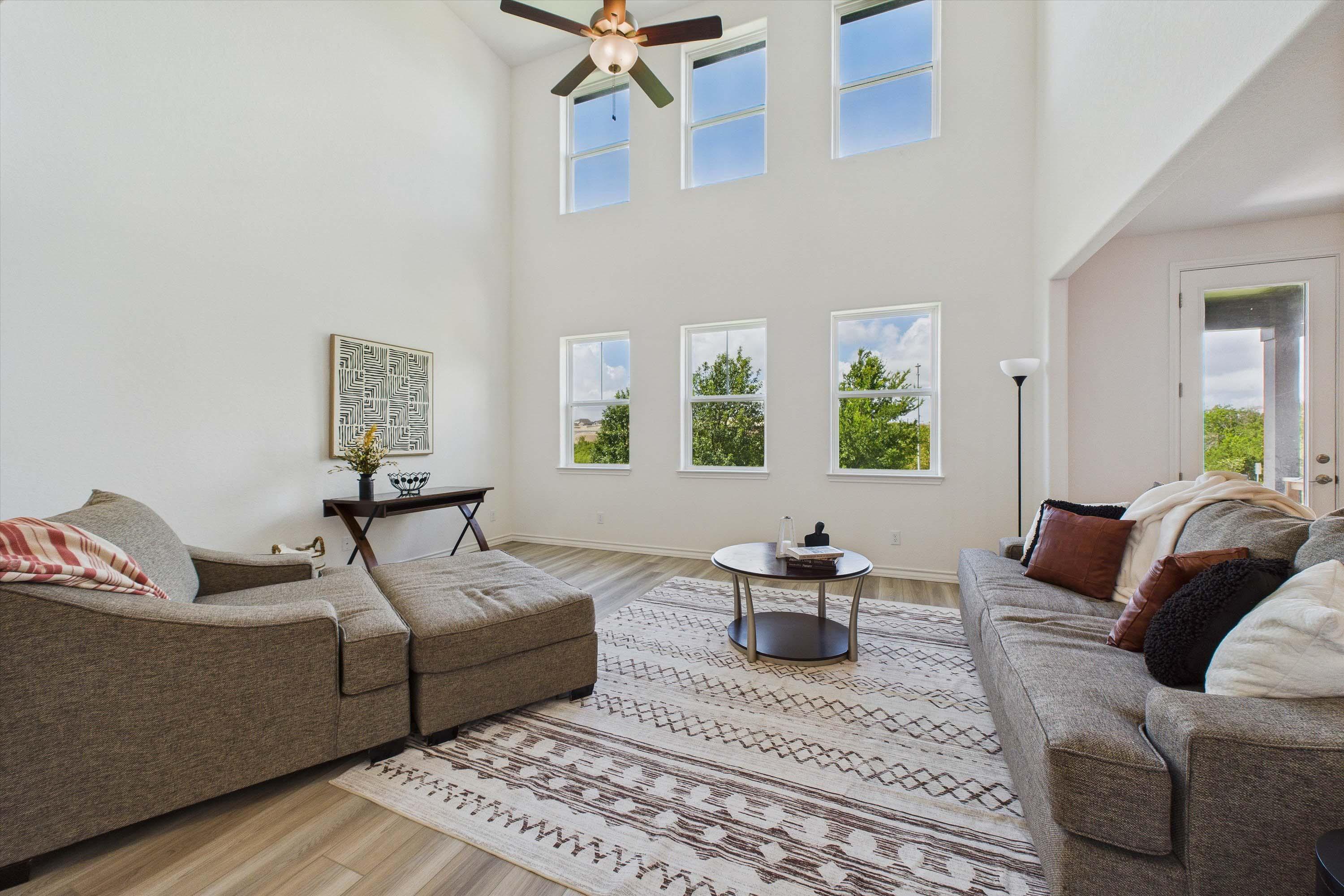 Spacious two-story living room in The Danbury by Davidson Homes featuring high ceilings and abundant natural light.