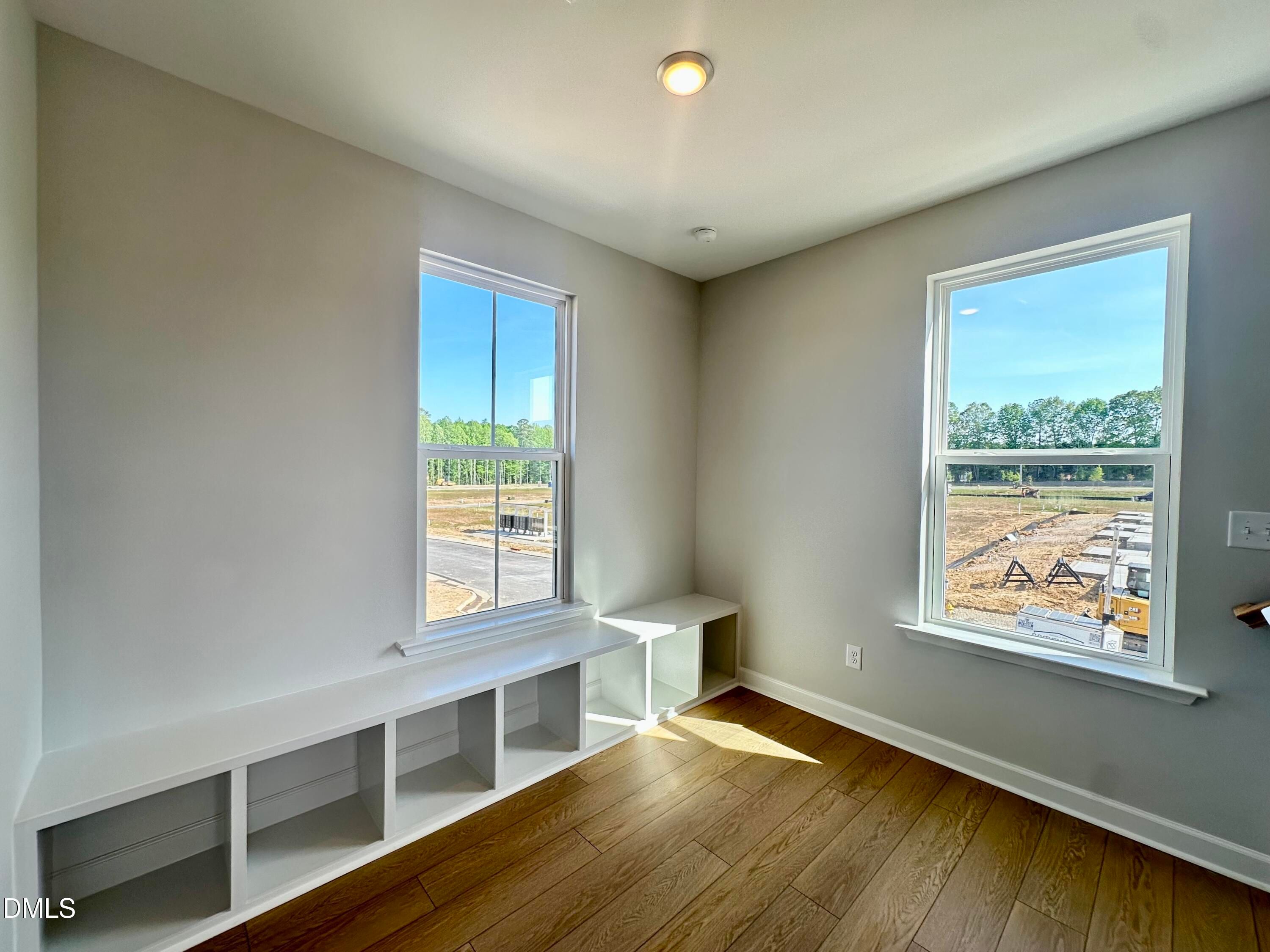 Sunlit window nook with white built-in bench and storage in The Avery 3-bedroom townhome, Knightdale, NC