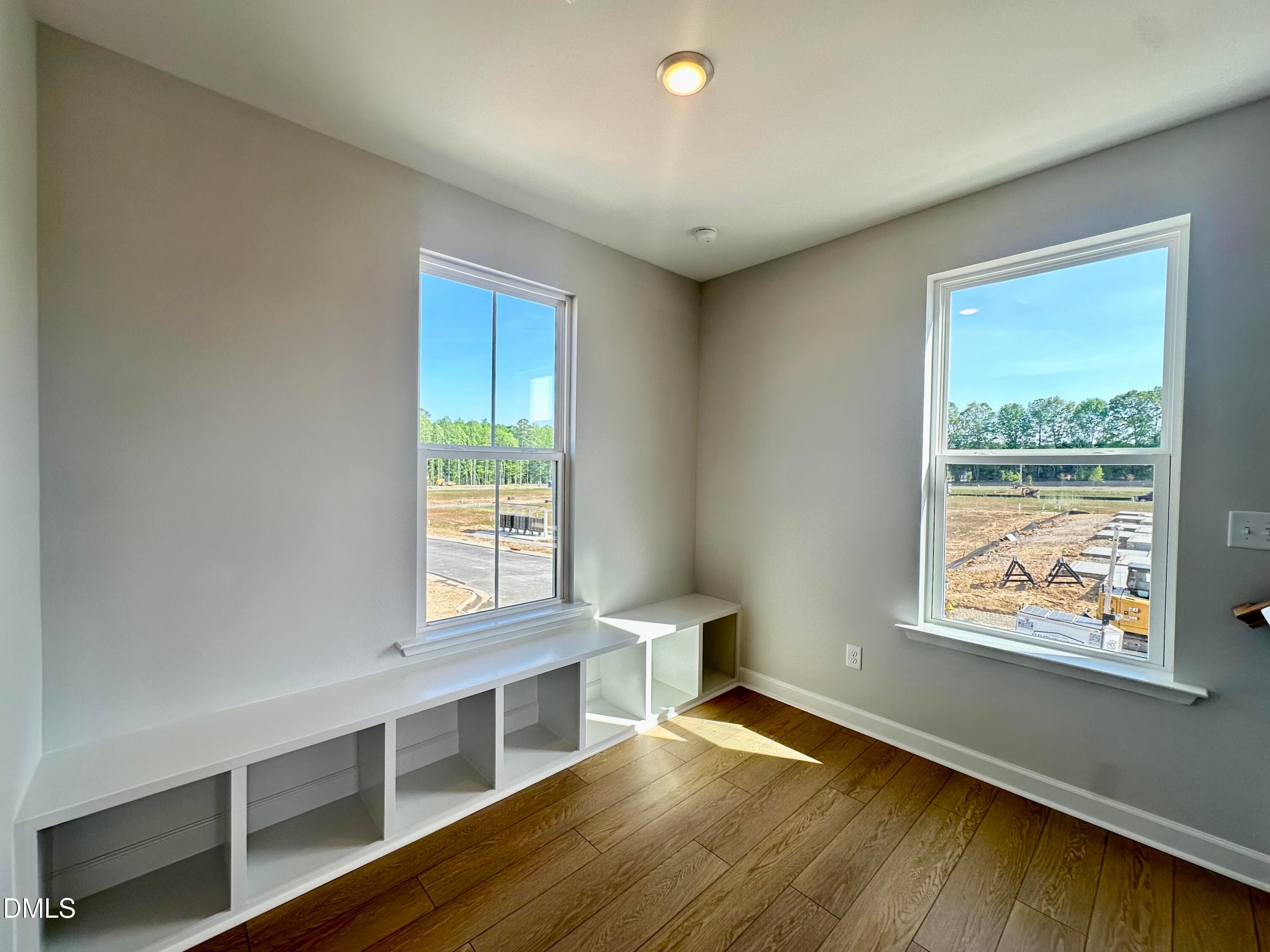 Sunlit window nook with white built-in bench and storage in The Avery 3-bedroom townhome, Knightdale, NC