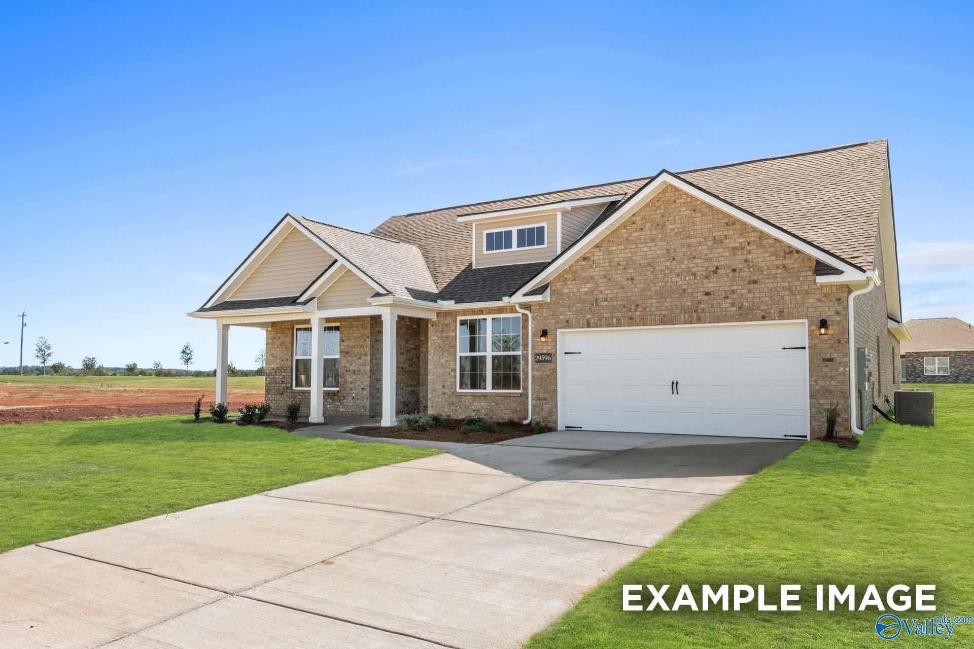 Brick single-story 4-bedroom home with 2-car garage, covered porch, and lush landscaping in Cain Park, Hartselle, Alabama - Davidson Homes The Harrison