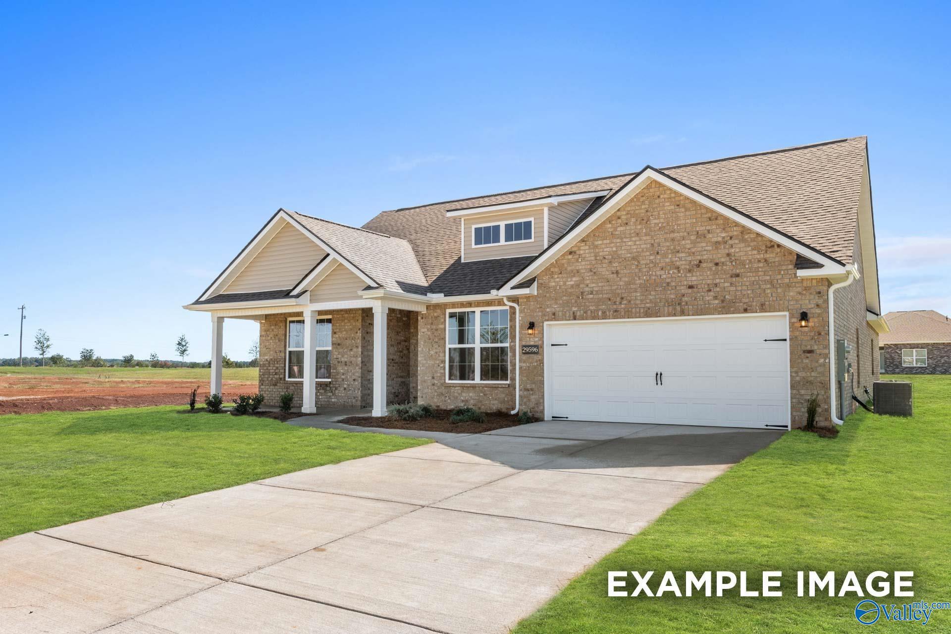 Brick single-story 4-bedroom home with 2-car garage, covered porch, and lush landscaping in Cain Park, Hartselle, Alabama - Davidson Homes The Harrison