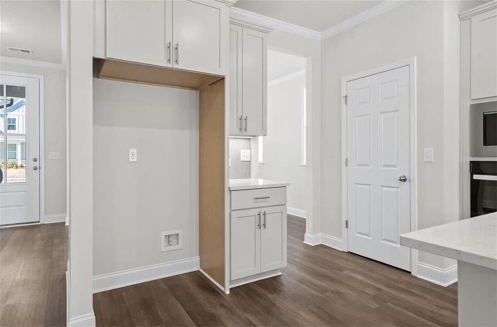 Modern kitchen pantry area with white cabinetry in The Ash C floor plan at Wehunt Meadows, Hoschton, Georgia.
