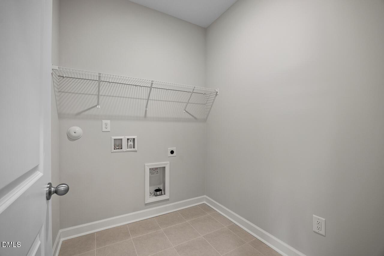 Laundry room with wire shelving and tile flooring in The Chestnut floor plan by Davidson Homes in Montrose, Aberdeen, NC.