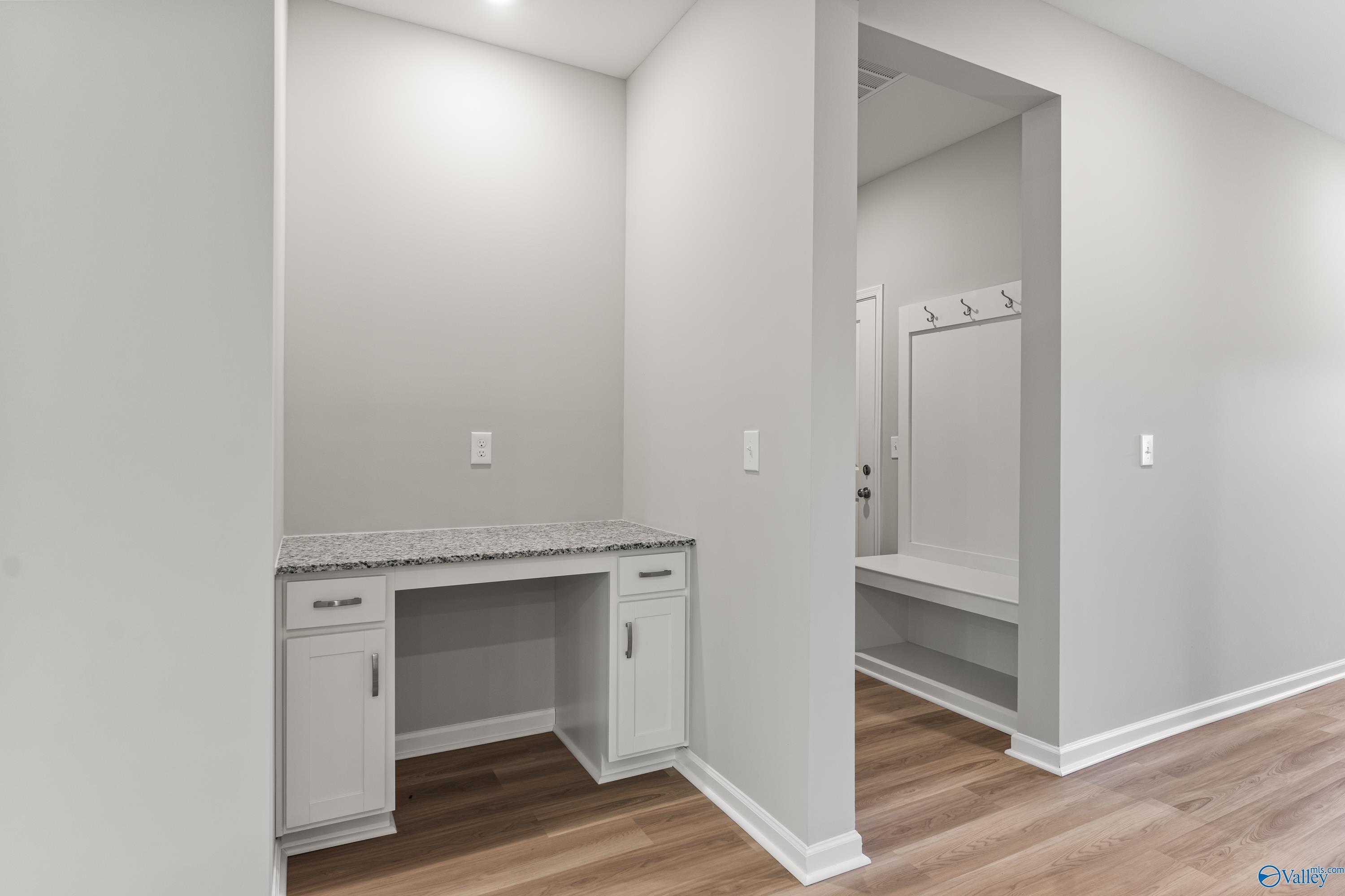 Built-in hallway desk with granite top and white cabinets in Davidson Homes The Phoenix, Hazel Green, Alabama