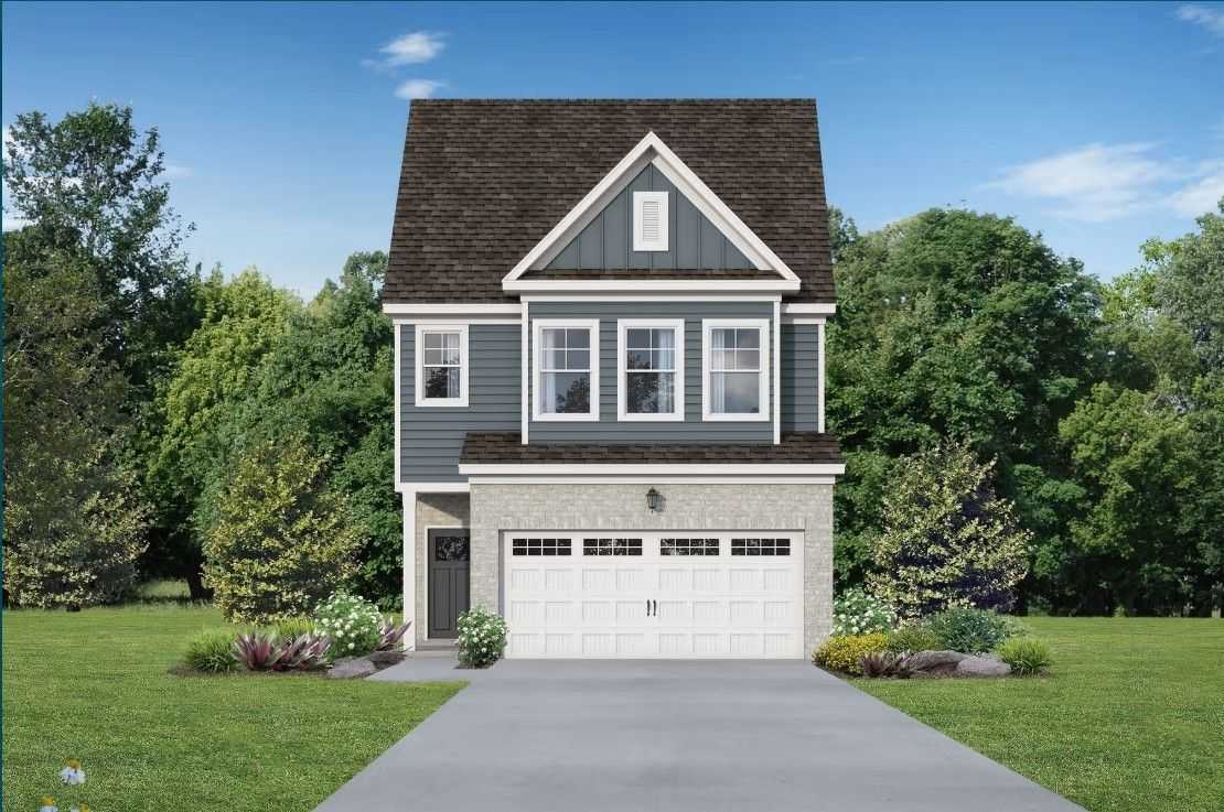 Modern two-story blue home with 2-car garage, gabled roof, and lush landscaping in Lake Park Villas, Wylie, Texas