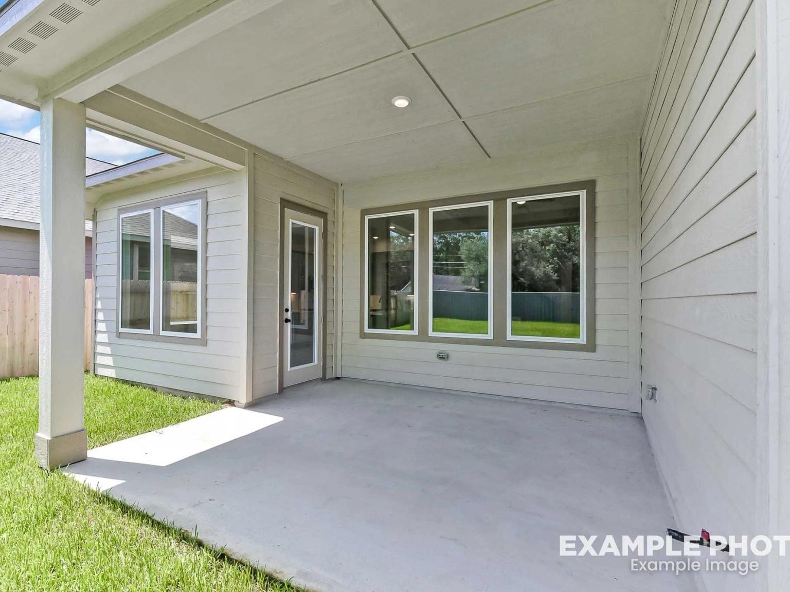 Covered back patio with light siding in The Sequoia C floor plan at Sundance Cove, Crosby, Texas.