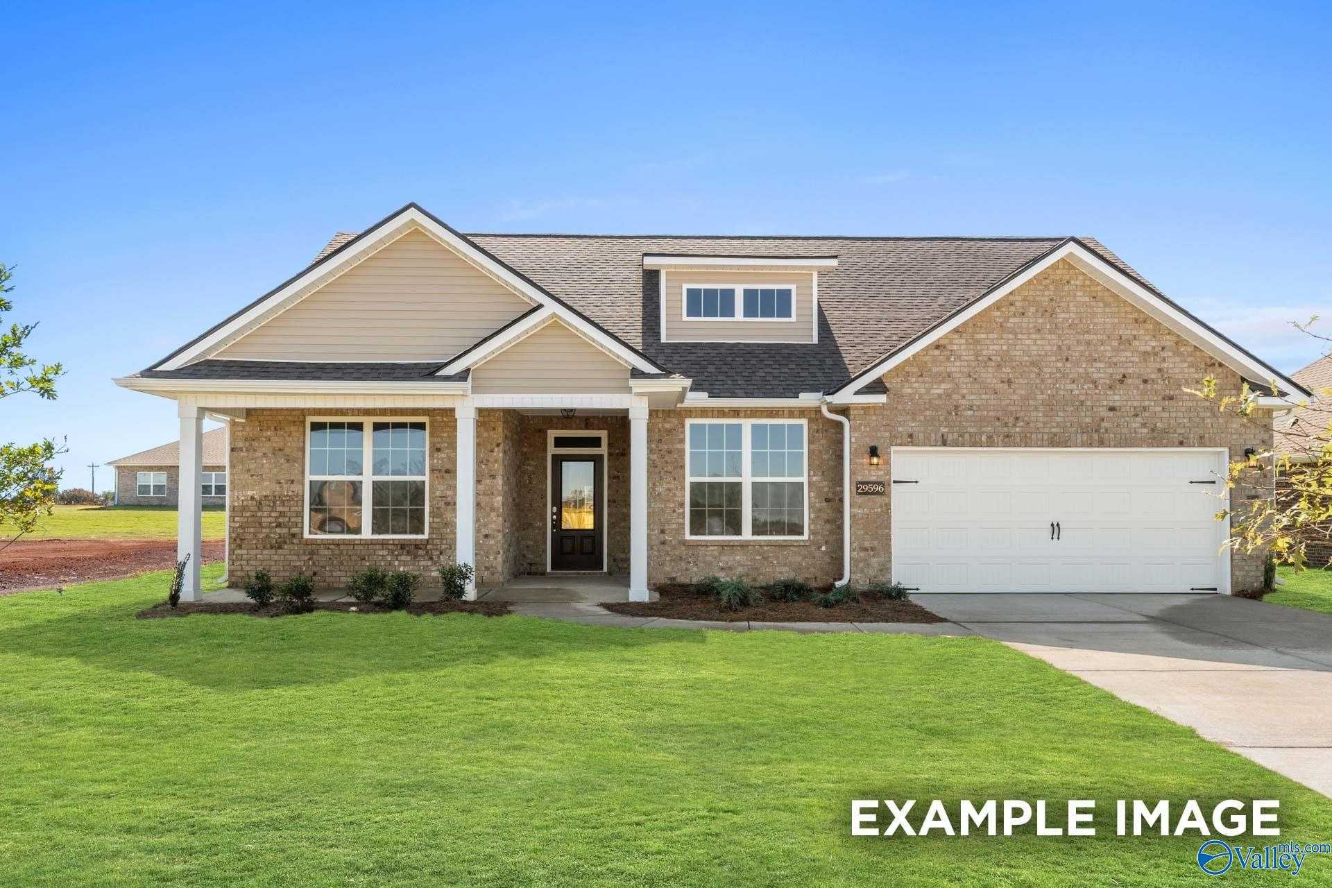 Brick single-story home with gabled roof, front porch, 2-car garage, and landscaped yard in Pikes Ridge, Meridianville, Alabama - Davidson Homes The Harrison