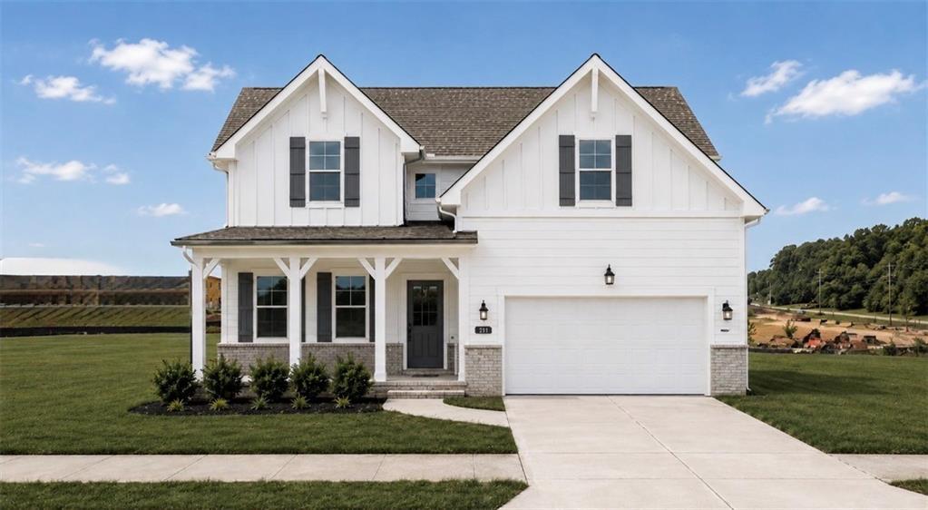 Two-story Hickory B floor plan by Davidson Homes with white siding and a two-car garage in Wehunt Meadows, Hoschton, Georgia.