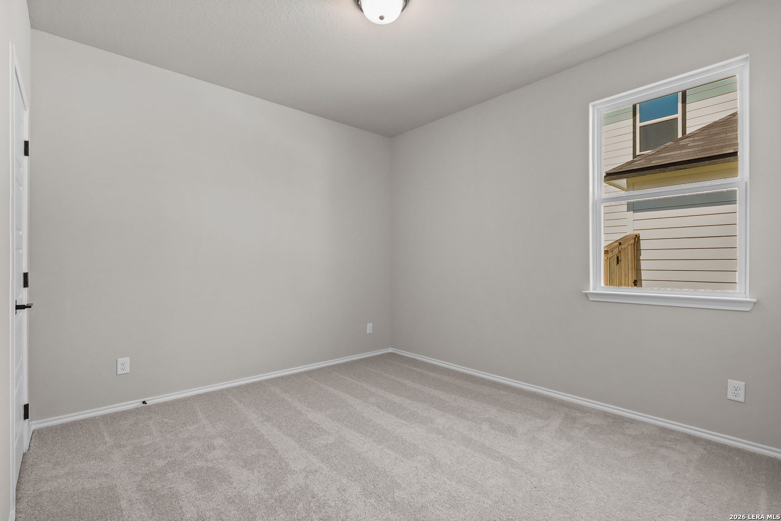 Neutral-toned bedroom with plush carpet in The Daphne H floor plan by Davidson Homes in Hannah Heights, Seguin, Texas.