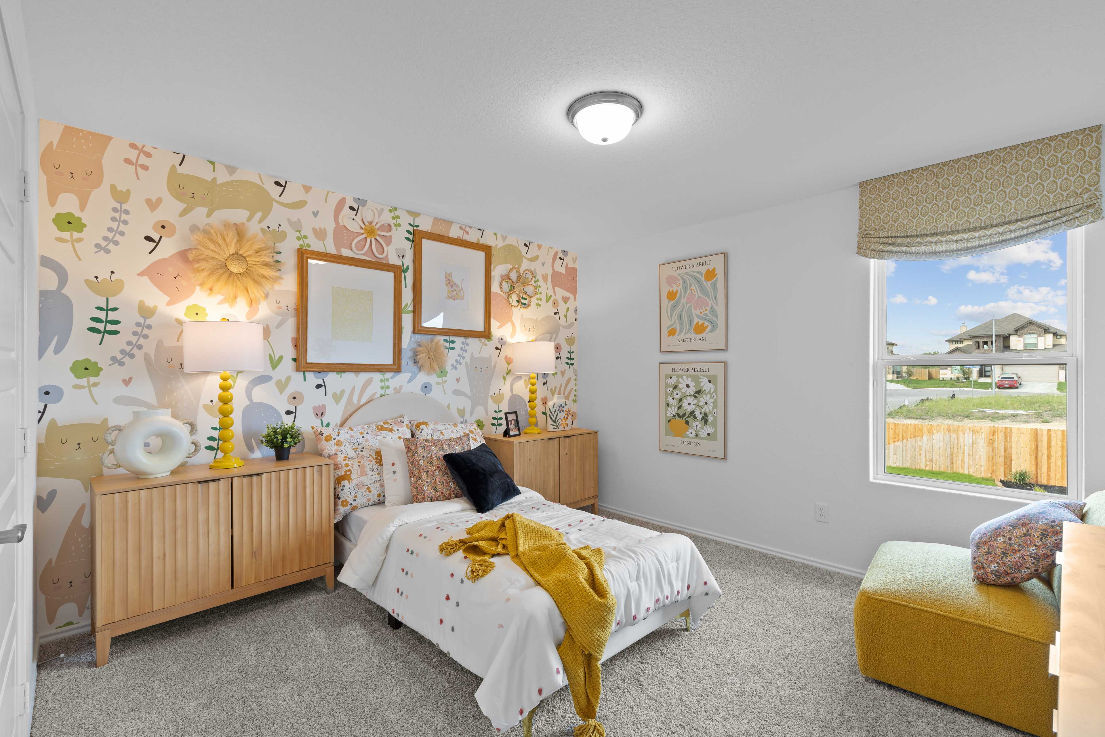 Whimsical children's bedroom at Horizon Pointe in Converse Texas with animal print wallpaper, floral twin bed, wooden nightstands, and window view