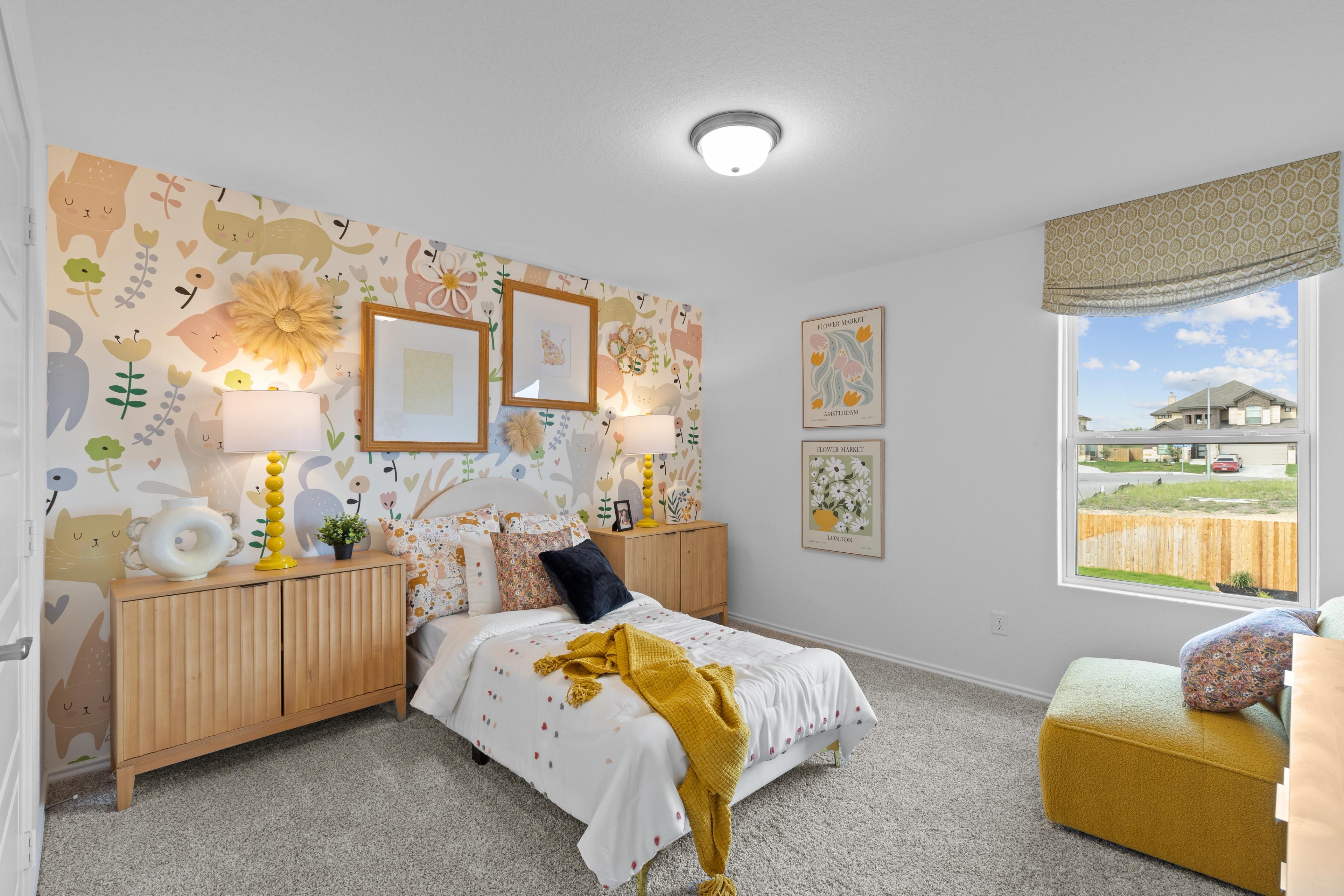 Whimsical children's bedroom at Horizon Pointe in Converse Texas with animal print wallpaper, floral twin bed, wooden nightstands, and window view