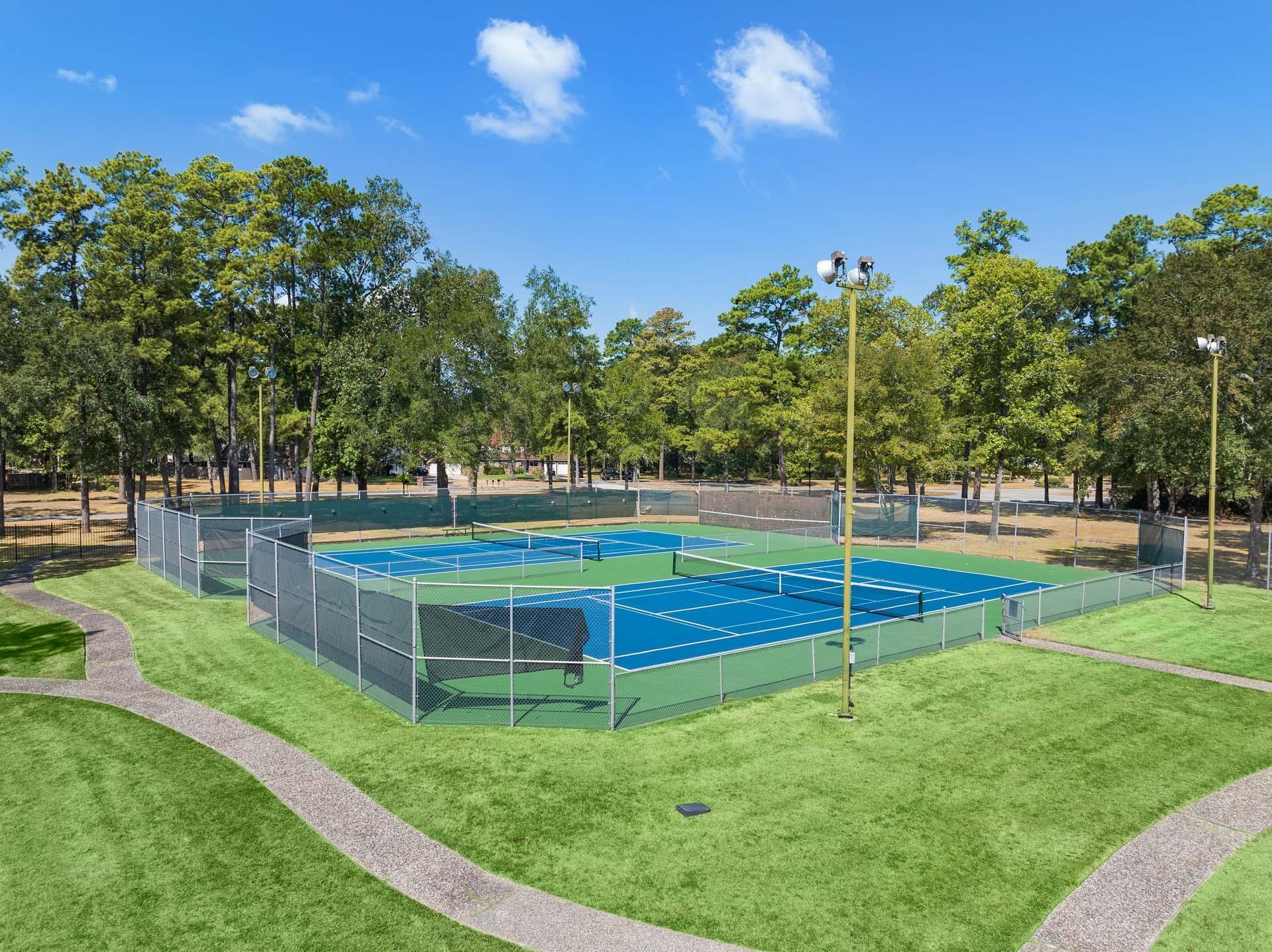 Outdoor tennis courts at Enclave at Newport community amenities in Crosby, Texas near Davidson Homes properties.