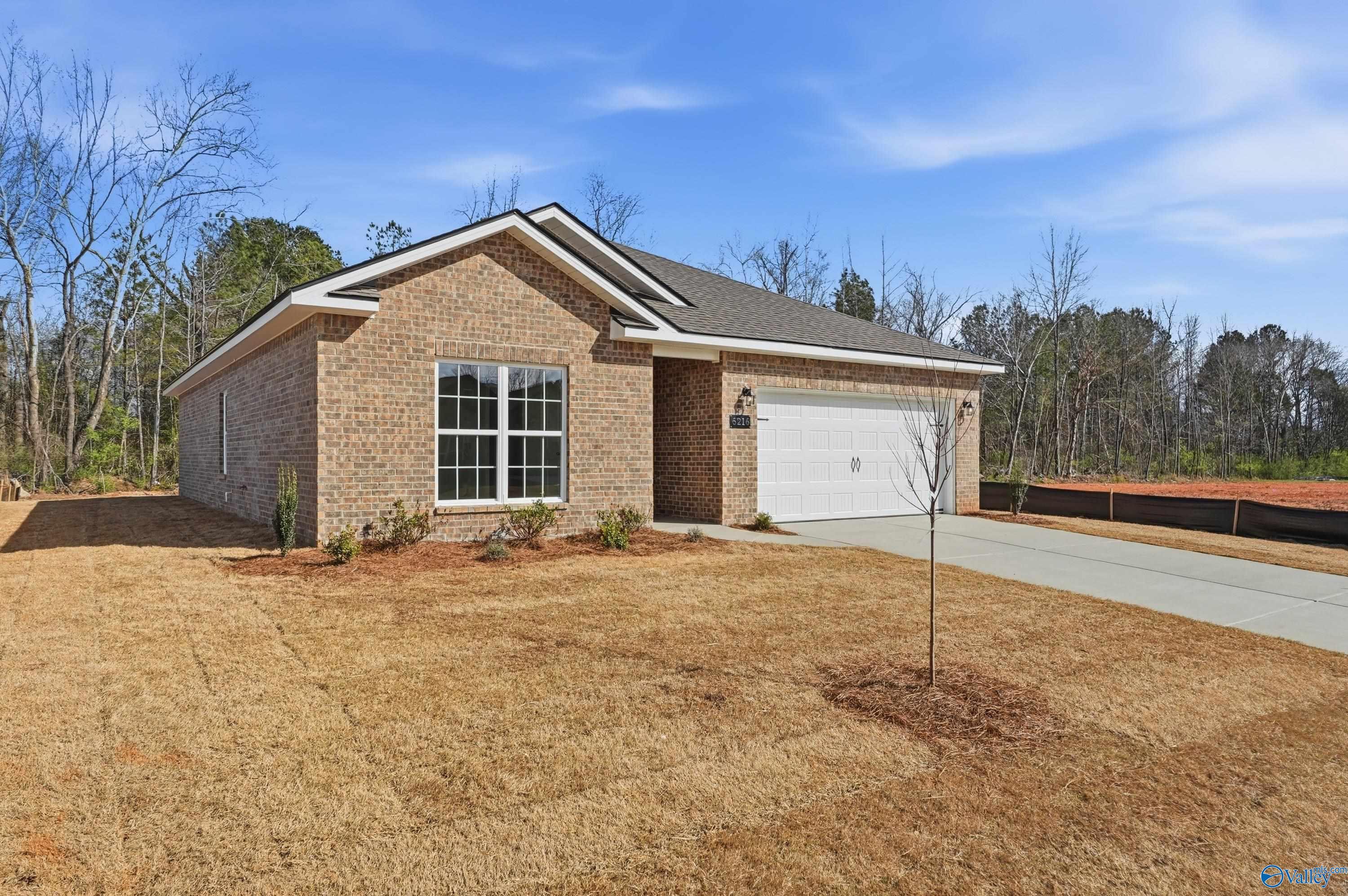 The Asheville 1-story brick home with 2-car garage, large windows, and front yard in Spragins Cove, Huntsville, Alabama