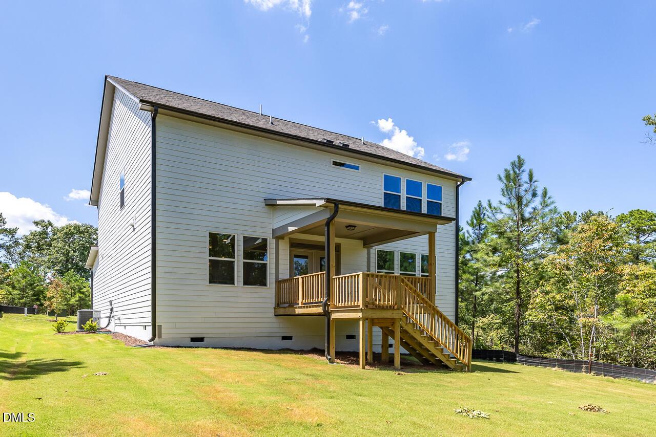 Back exterior view of The Chestnut floor plan by Davidson Homes featuring a wooden deck in Montrose, Aberdeen, NC.