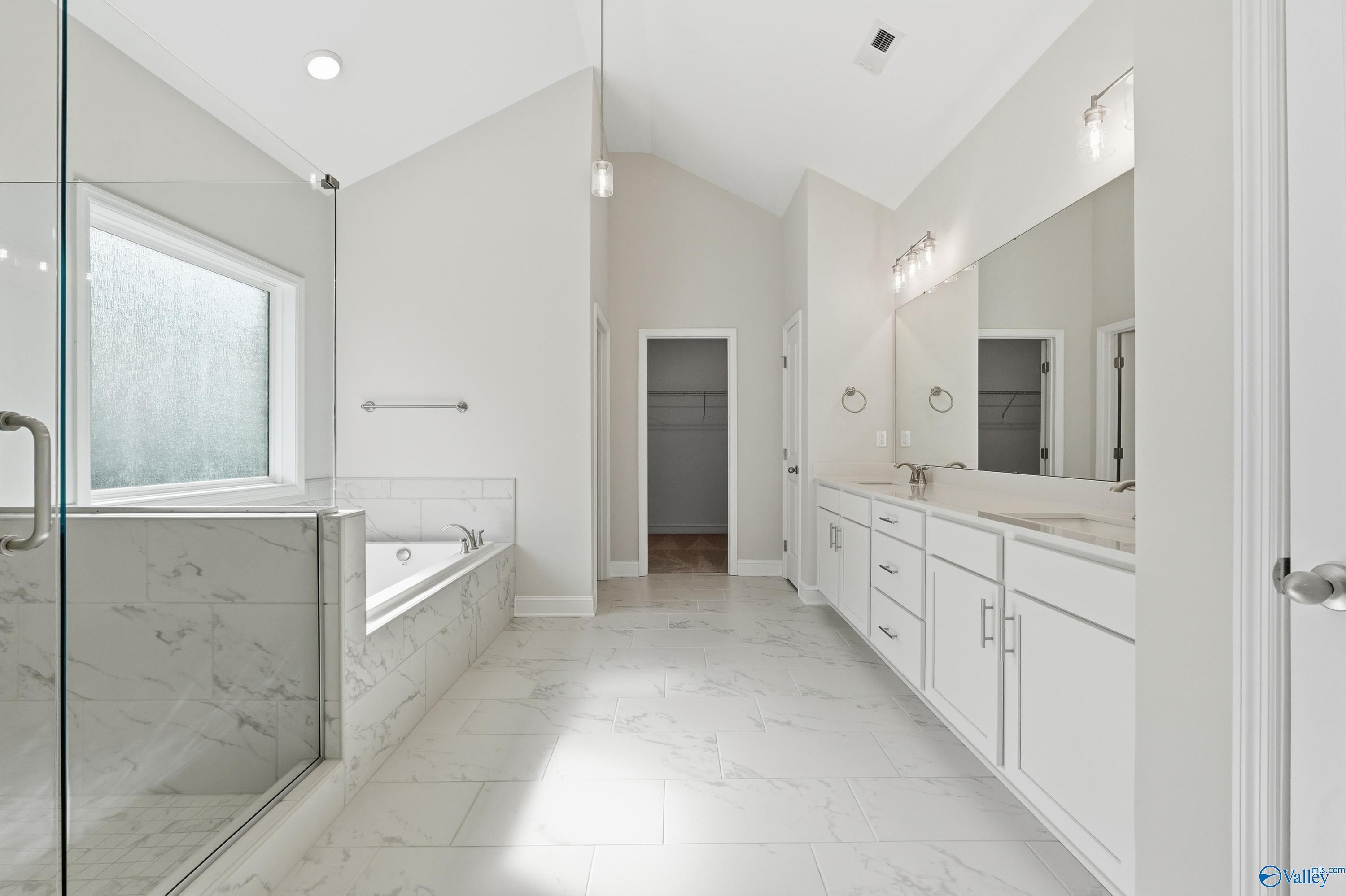Luxurious master bathroom with freestanding tub, glass shower, double vanity in Davidson Homes The Finleigh, Harvest, Alabama