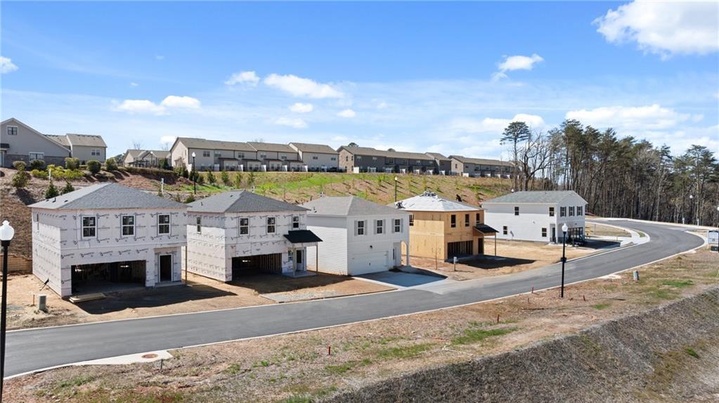 Under-construction 2-story craftsman homes with 2-car garages in The Bluffs, Canton, Georgia by Davidson Homes