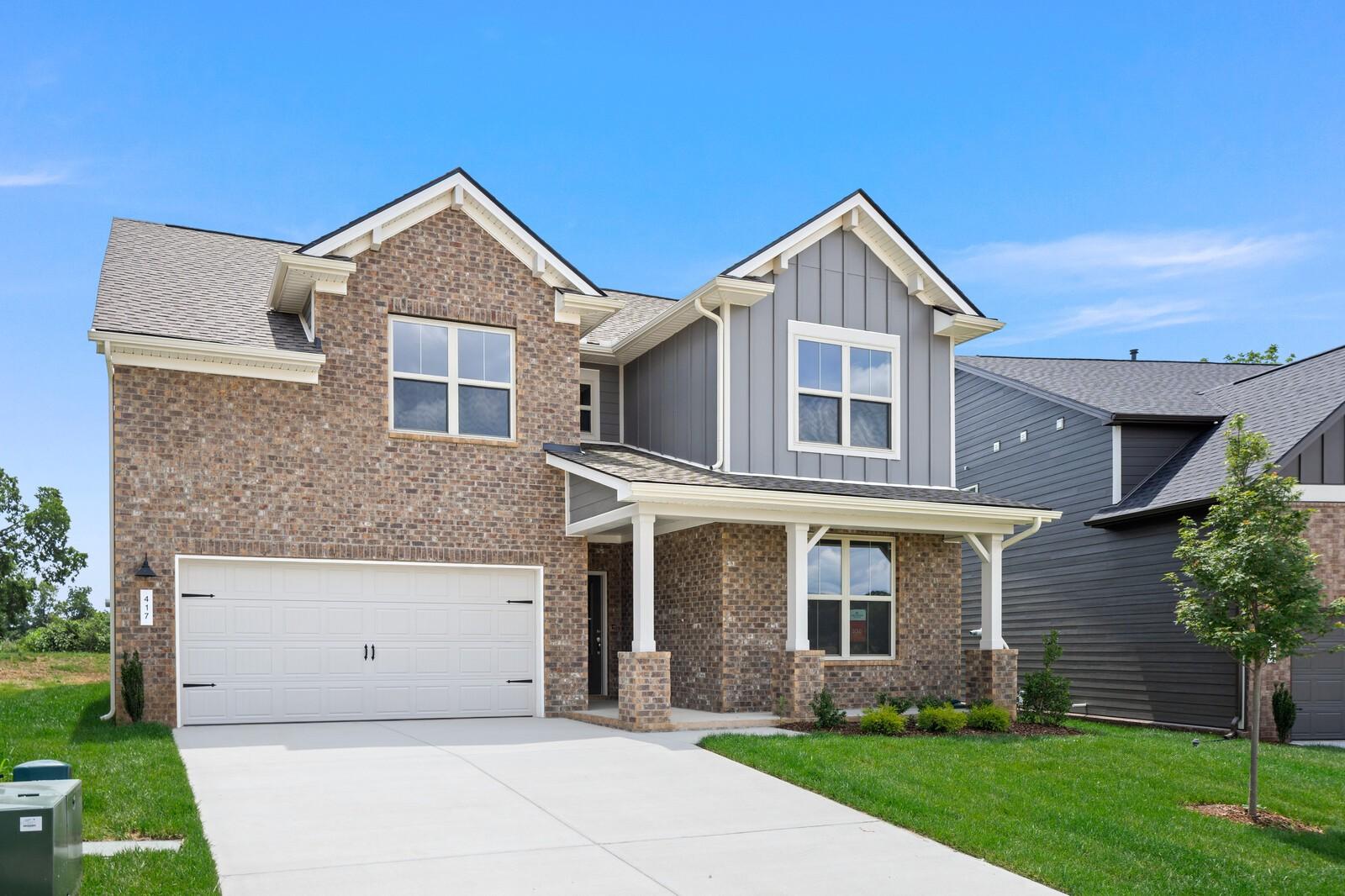 Two-story brick and siding home exterior featuring The Ridgeport C floor plan by Davidson Homes in Gallatin, Tennessee.
