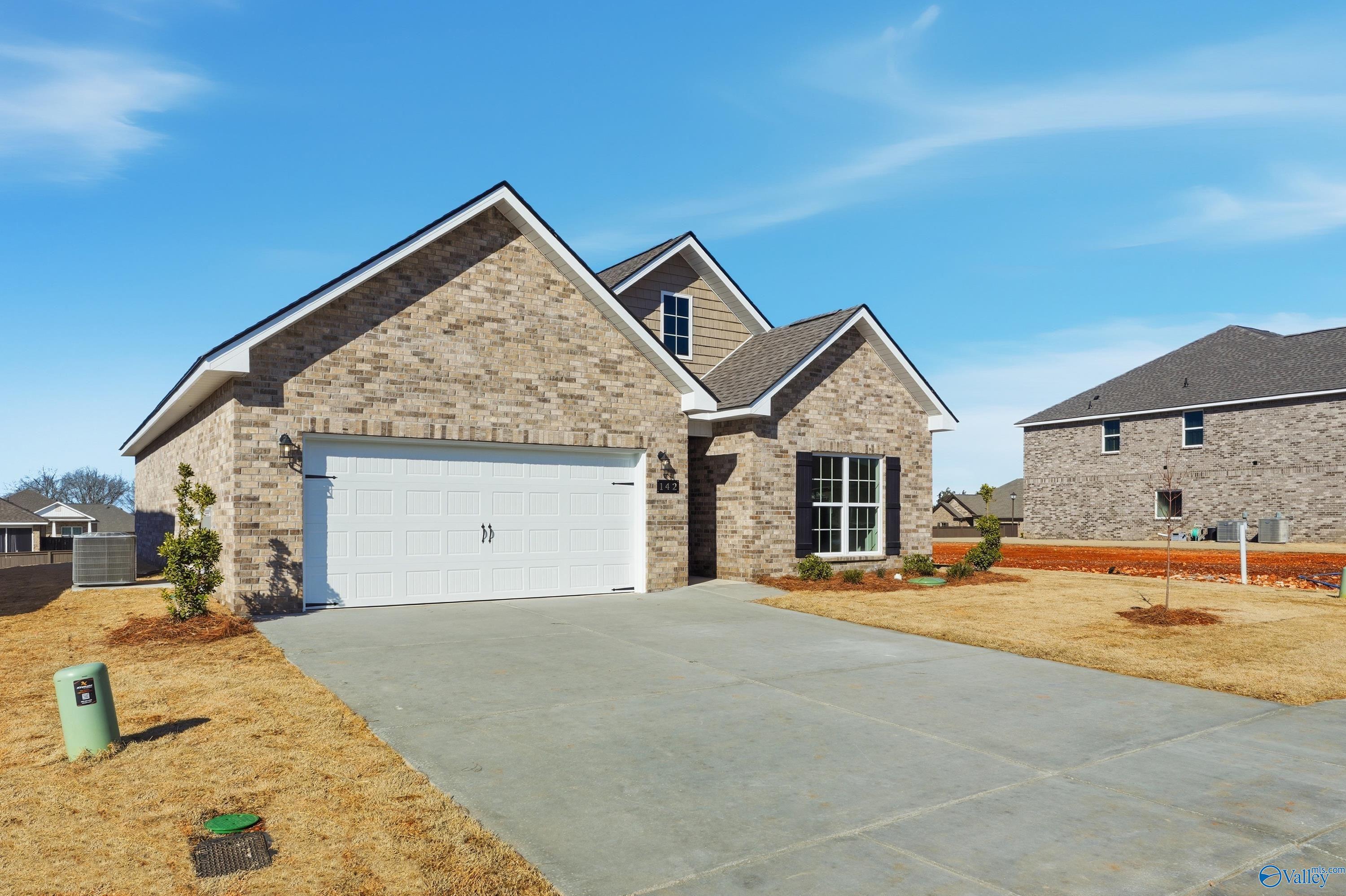 Brick single-story home with 2-car garage, driveway, and landscaping in Creek Grove, New Market, Alabama by Davidson Homes