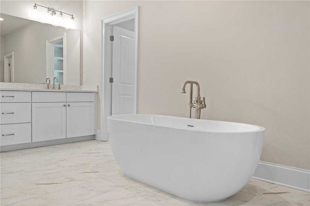 Luxurious master bathroom with freestanding tub, double vanity, and neutral tones in Davidson Homes The Arlington A, East Cobb, Georgia