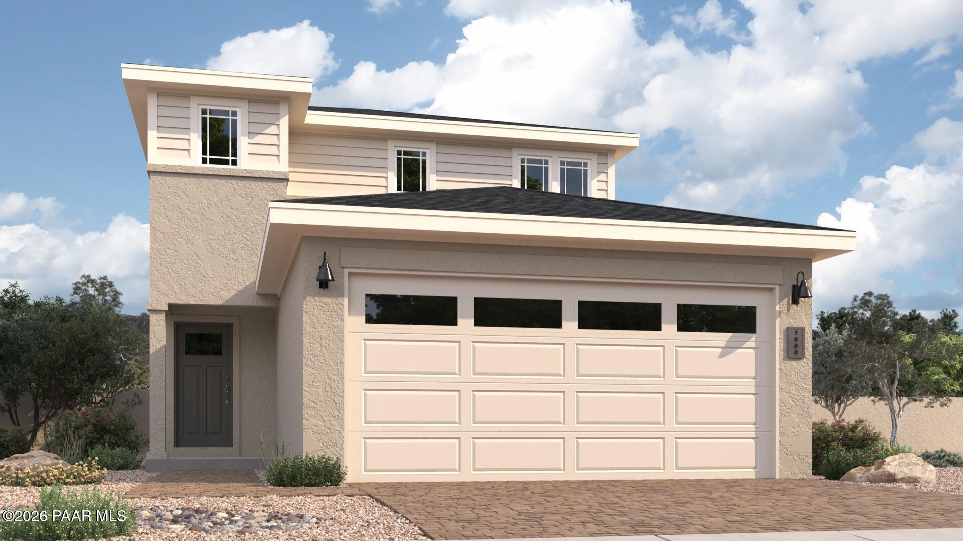 Modern two-story beige home with 2-car garage, front entry, and desert landscaping in South Ranch, Prescott, Arizona