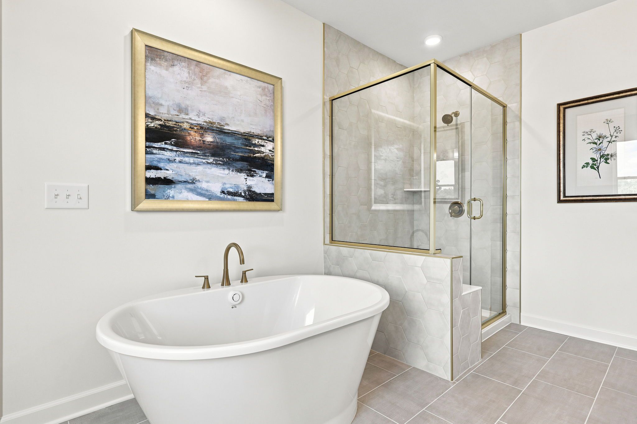 Luxury primary bathroom at Montrose in Aberdeen, NC by Davidson Homes featuring a freestanding tub and glass shower.
