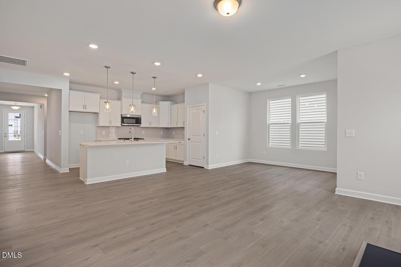 Open-concept kitchen and living area in The Daphne D floor plan at Woodland Crossing, Zebulon, North Carolina.