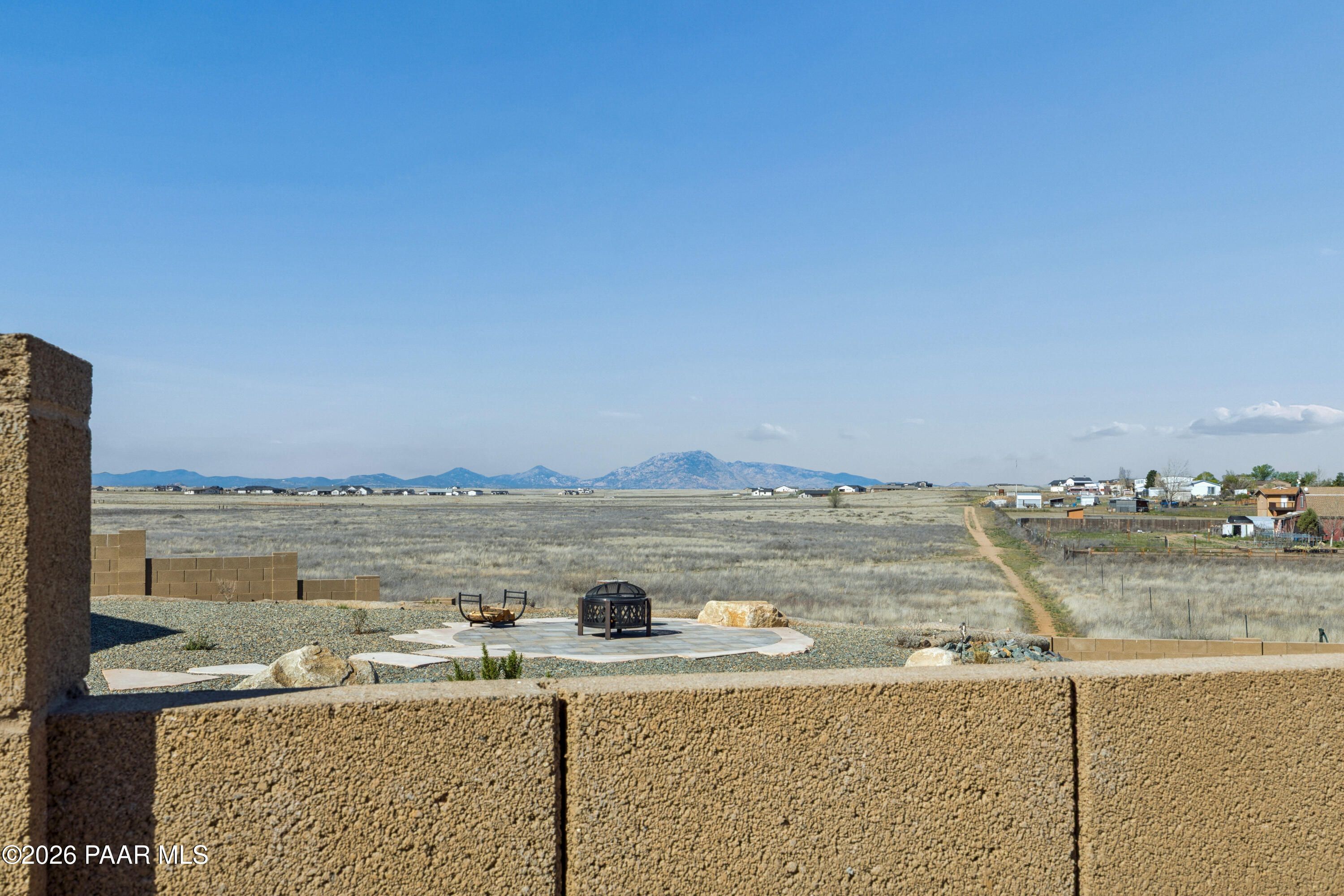 Outdoor fire pit in rocky backyard with desert mountain views, Davidson Homes The Harmony A, Pronghorn Ranch, Prescott Valley, AZ