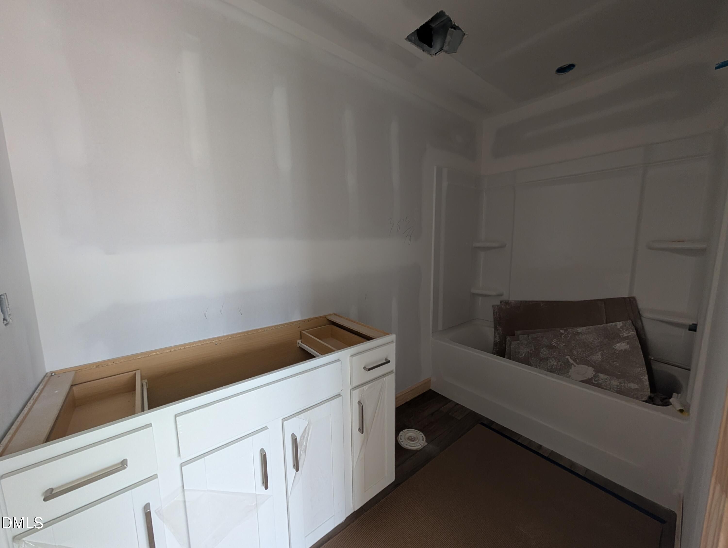 Bathroom under construction with white vanity cabinet and tub-shower combo in The Beech floor plan home by Davidson Homes, Wendell Ridge, NC