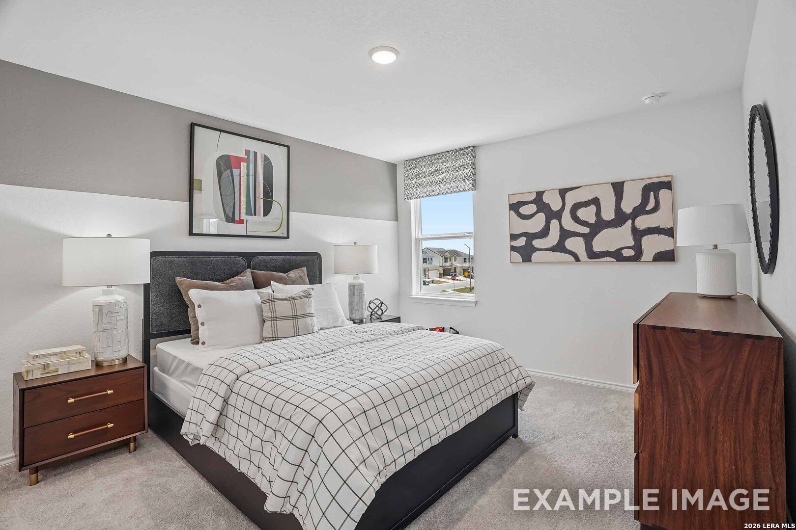 Bright staged bedroom with upholstered headboard and modern decor in Davidson Homes' Pinecrest E floor plan, Converse, Texas