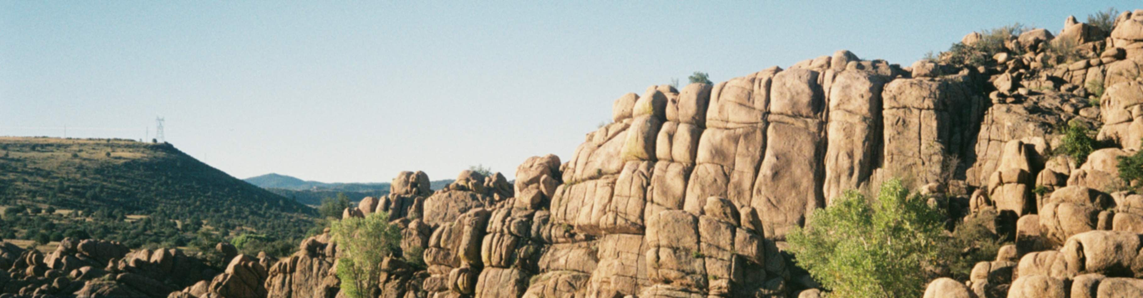 Rugged granite cliffs and serene lake in Prescott Valley, ideal for new home communities