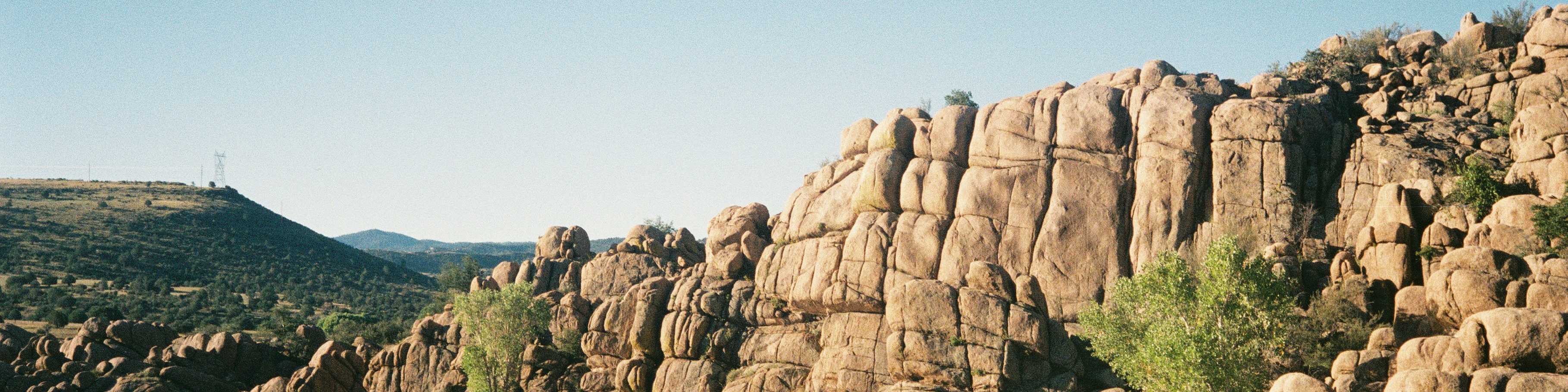 Rugged granite cliffs and serene lake in Prescott Valley, ideal for new home communities