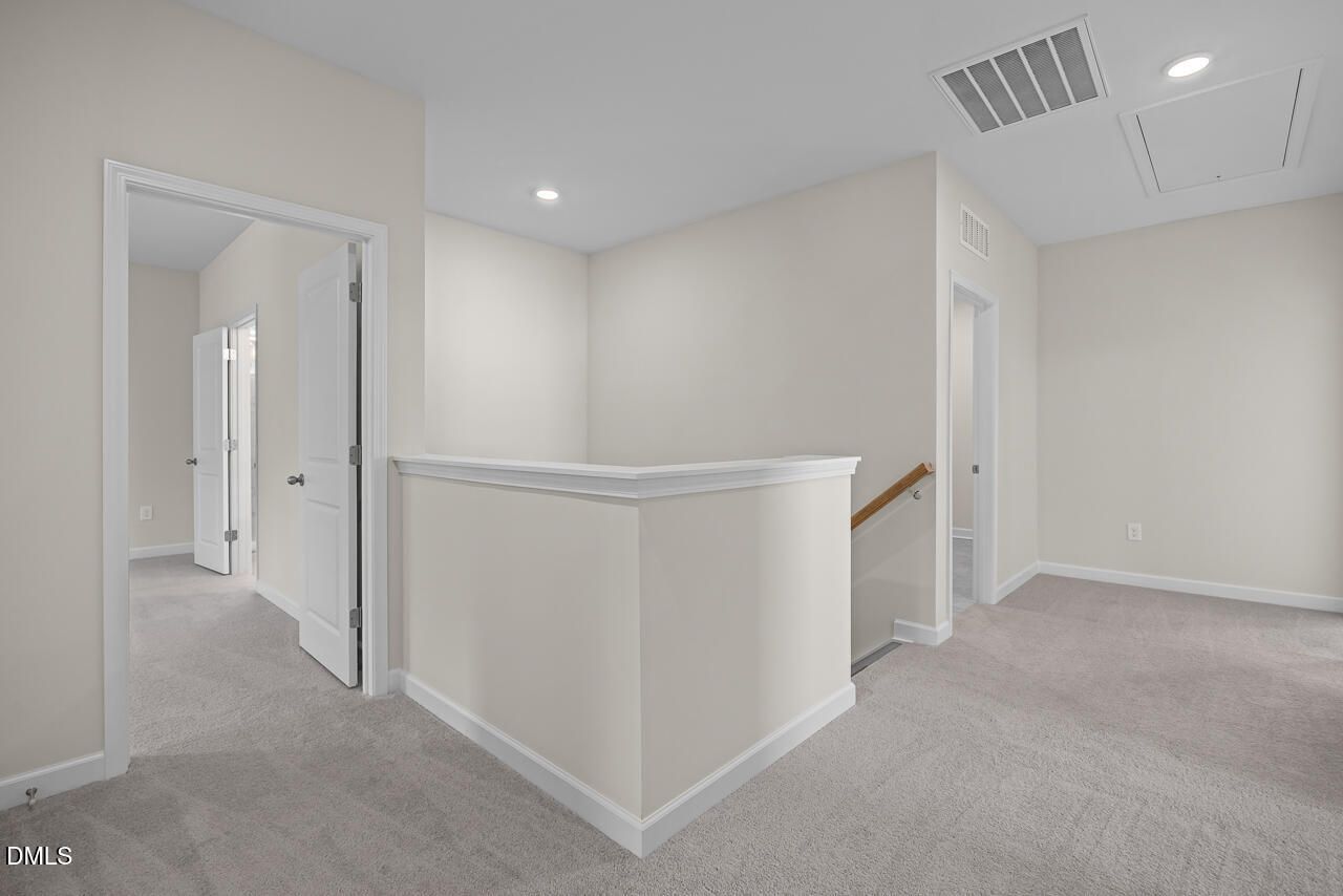 Spacious second-floor landing area with plush carpet in The Hickory II B floor plan by Davidson Homes in Montrose, Aberdeen.