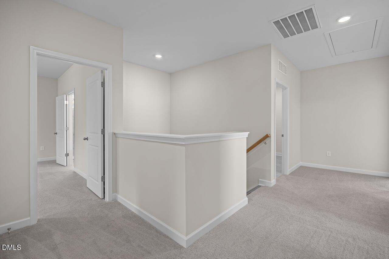 Spacious second-floor landing area with plush carpet in The Hickory II B floor plan by Davidson Homes in Montrose, Aberdeen.