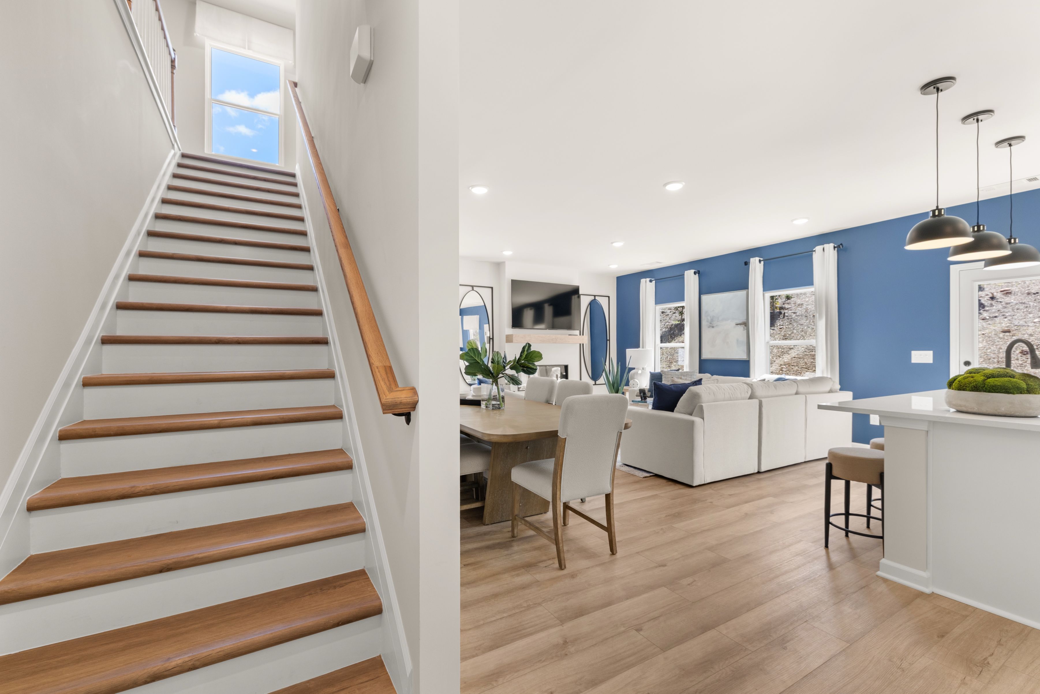 Modern open-concept interior with oak staircase, hardwood floors, living room, dining area, and kitchen at The Bluffs Canton GA