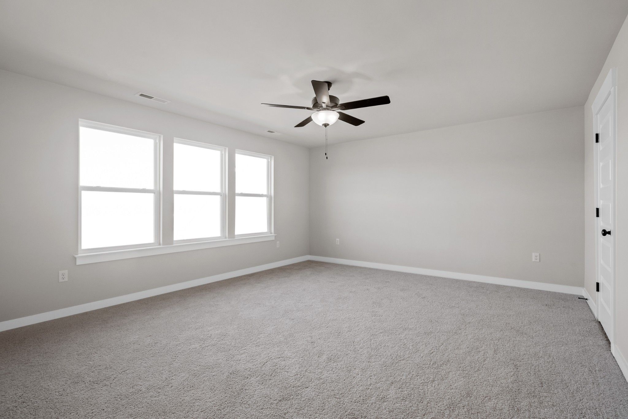 Bright secondary bedroom with gray carpet, large windows, ceiling fan in Davidson Homes The Willow B, Calista Farms, White House, TN