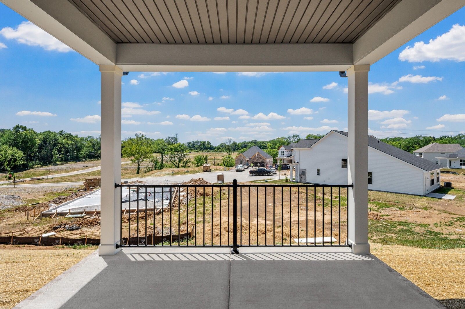 Covered patio view overlooking the Woods Crossing community construction in Gallatin, Tennessee by Davidson Homes.