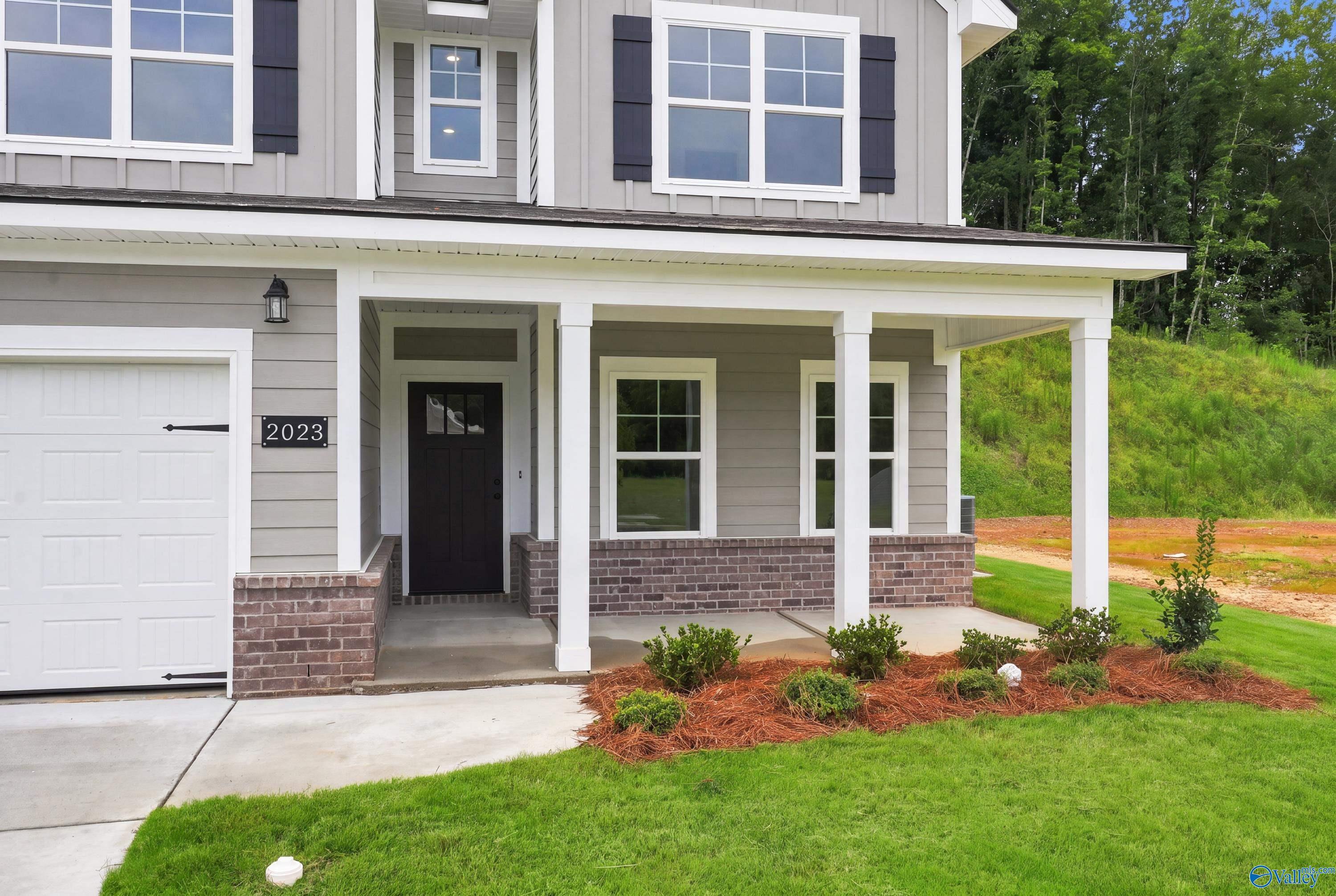 Two-story Shelby D floor plan by Davidson Homes with a covered front porch and two-car garage in Noble Ridge, Cullman, AL.