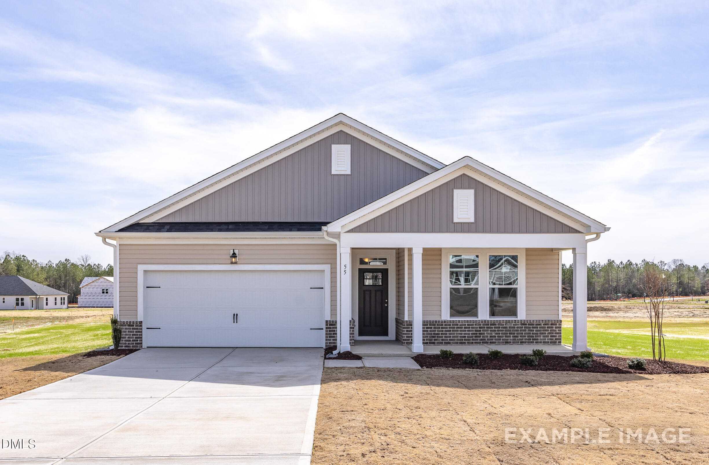 Modern gray-sided single-story home with 2-car garage, columned front porch, and landscaped yard in Lillington, North Carolina