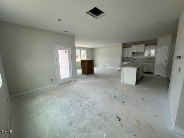 Open-concept kitchen with white shaker cabinets, central island, and French doors in new 4-bedroom Preston A home, Lillington, NC