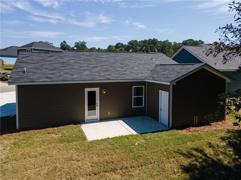 Rear view of The Washington 3-bedroom home by Davidson Homes with covered patio and attached garage in Summer Vineyard, Phenix City, Alabama